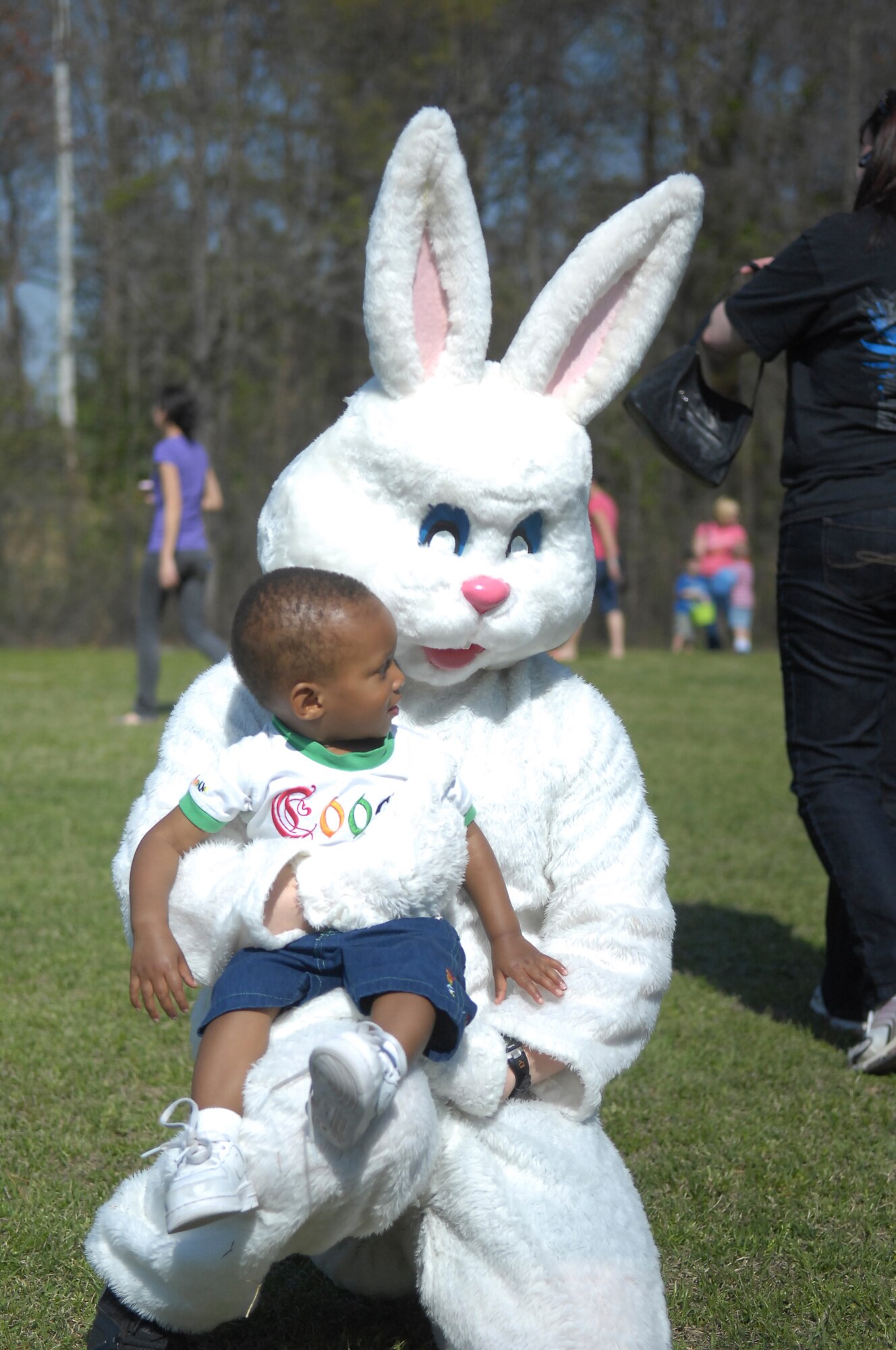 The Easter Bunny holds a child during Pope’s Annual Easter Egg Hunt at Woodland Park April 2. The event, hosted by the Pope Library and 43rd SFS, gave families a chance to have fun, play games and enjoy the sunshine. (U.S. Air Force Photo by 2nd Lt. Cammie Quinn)