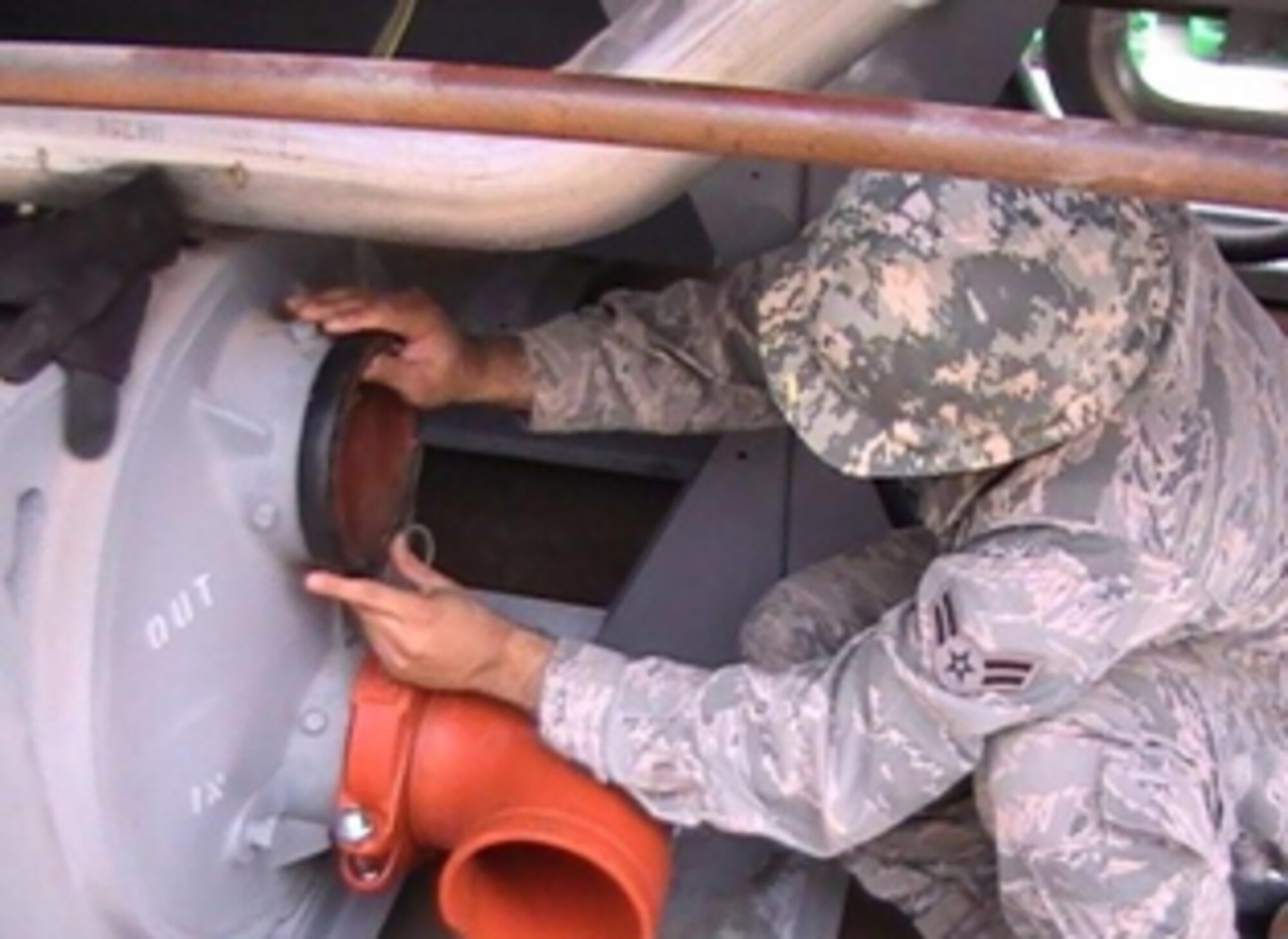 HOLLOMAN AIR FORCE BASE, N.M. -- Airman 1st Class Bryan Avila, 49th Civil Engineer Squadron, installs a new high-efficiency chiller at the German Air Force Headquarters building. This maintenance is being accomplished early in the "No-Heat, No-Cool" season. Members of the 49th CES will begin turning off heat to buildings as part of the base No-Heat, No-Cool program which can save the base up to five percent, or $300,000, on it's annual energy bills. (Courtesy photo)