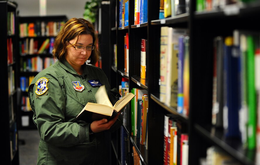 OFFUTT AIR FORCE BASE, Neb. -- Master Sgt. Paula Malott, an Arabic Linguist and chief of Standardization and Evaluations with the 97th Intelligence Squadron, thumbs through an Arabic to English dictionary at the Language Learning Center here March 31. Linguists like Sergeant Malott take utilize the LLC and its many resources to maintain language proficiency. Sergeant Malott has spent her 20-plus year career with the Air Force as a linguist and has deployed more than 20 times in support of contingency operations. U.S. Air Force photo by Josh Plueger