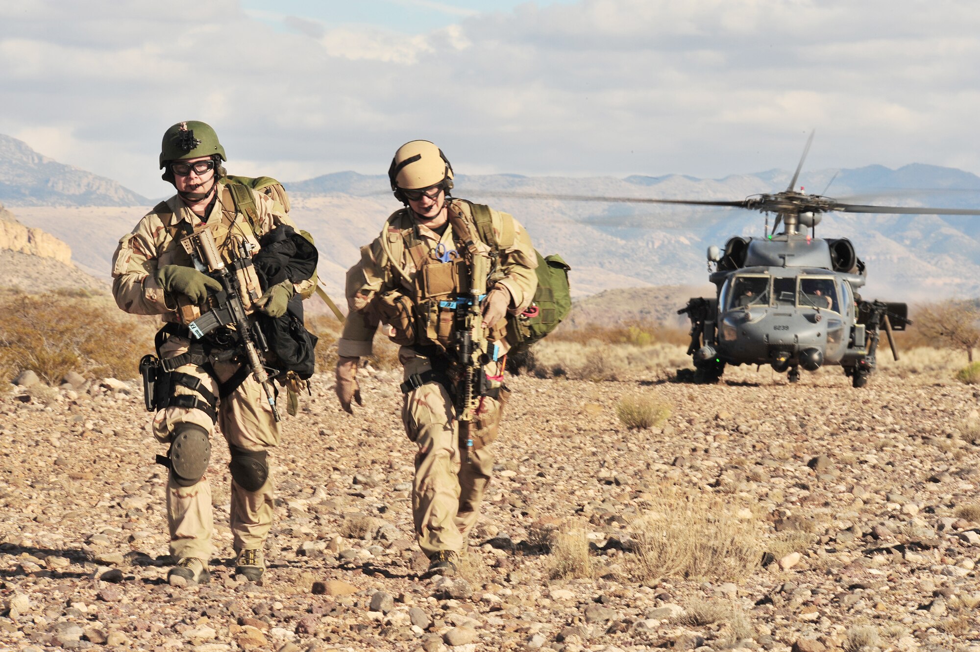 Two Air Force pararescuemen depart from a HH-60G Pave Hawk helicopter to aid casualties during Exercise Angel Thunder 2008. More than 800 ground recovery members took part in Angel Thunder 2008, the world's largest personnel recovery and combat search and rescue exercise. Angel Thunder 2010 is scheduled for April 12 through 23 at Davis-Monthan Air Force Base, Ariz. (U.S. Air Force photo/Senior Airman Noah R. Johnson)