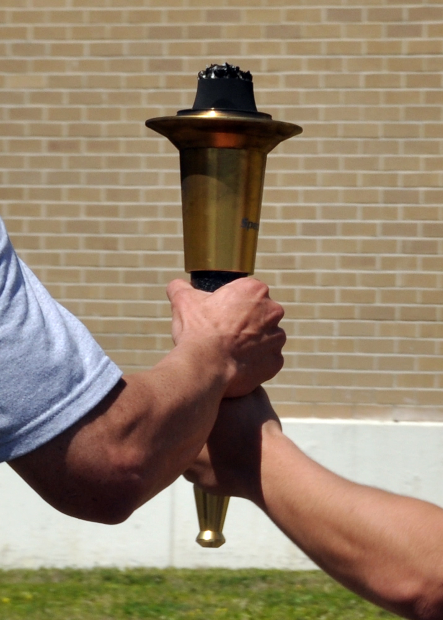 EGLIN AIR FORCE BASE, Fla. –  Members of the 96th Security Forces Squadron and Ground Combat Training Squadron take turns holding the Torch of Hope while running across base for the 12th Annual Florida Torch Run, March 31. The event is a grassroots program supported by local police departments as a fundraiser for the Special Olympics. The Niceville Police Department handed the Torch of Hope to 96th SFS who then handed it to Fort Walton Beach Police Department. (U.S. Air Force photo/ Airman 1st Class Anthony Jennings)