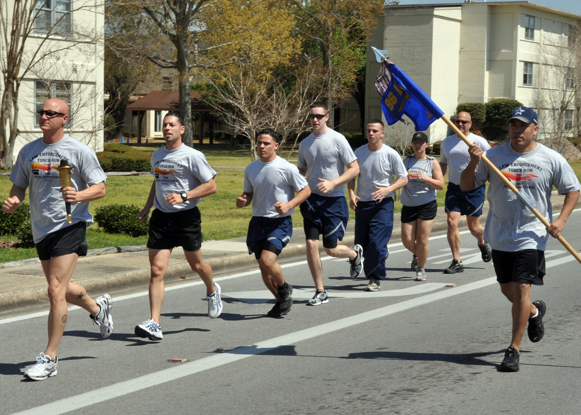 EGLIN AIR FORCE BASE, Fla. – The Torch of Hope is passed among members of the 96th Security Forces Squadron and Ground Combat Training Squadron during the 12th Annual Florida Torch Run, March 31. The event is a grassroots program supported by local police departments as a fundraiser for the Special Olympics. The Niceville Police Department handed the Torch of Hope to 96th SFS who then handed it to Fort Walton Beach Police Department. (U.S. Air Force photo/ Airman 1st Class Anthony Jennings)