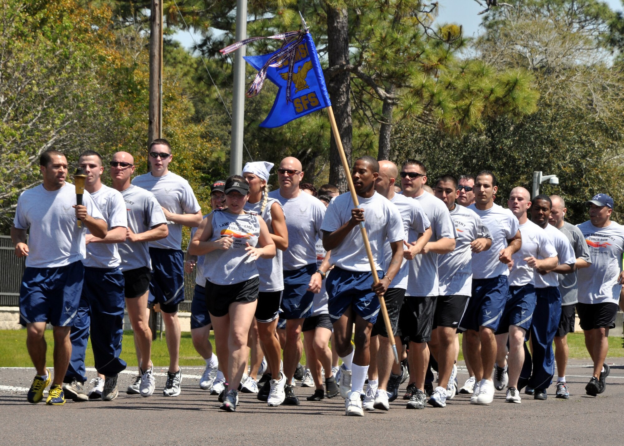 EGLIN AIR FORCE BASE, Fla. –  Forty-two members of the 96th Security Forces Squadron take turns holding the Torch of Hope while running across base for the 12th Annual Florida Torch Run, March 31. The event is a grassroots program supported by local police departments as a fundraiser for the Special Olympics. The Niceville Police Department handed the Torch of Hope to 96th SFS who then handed it to Fort Walton Beach Police Department. (U.S. Air Force photo/ Airman 1st Class Anthony Jennings)