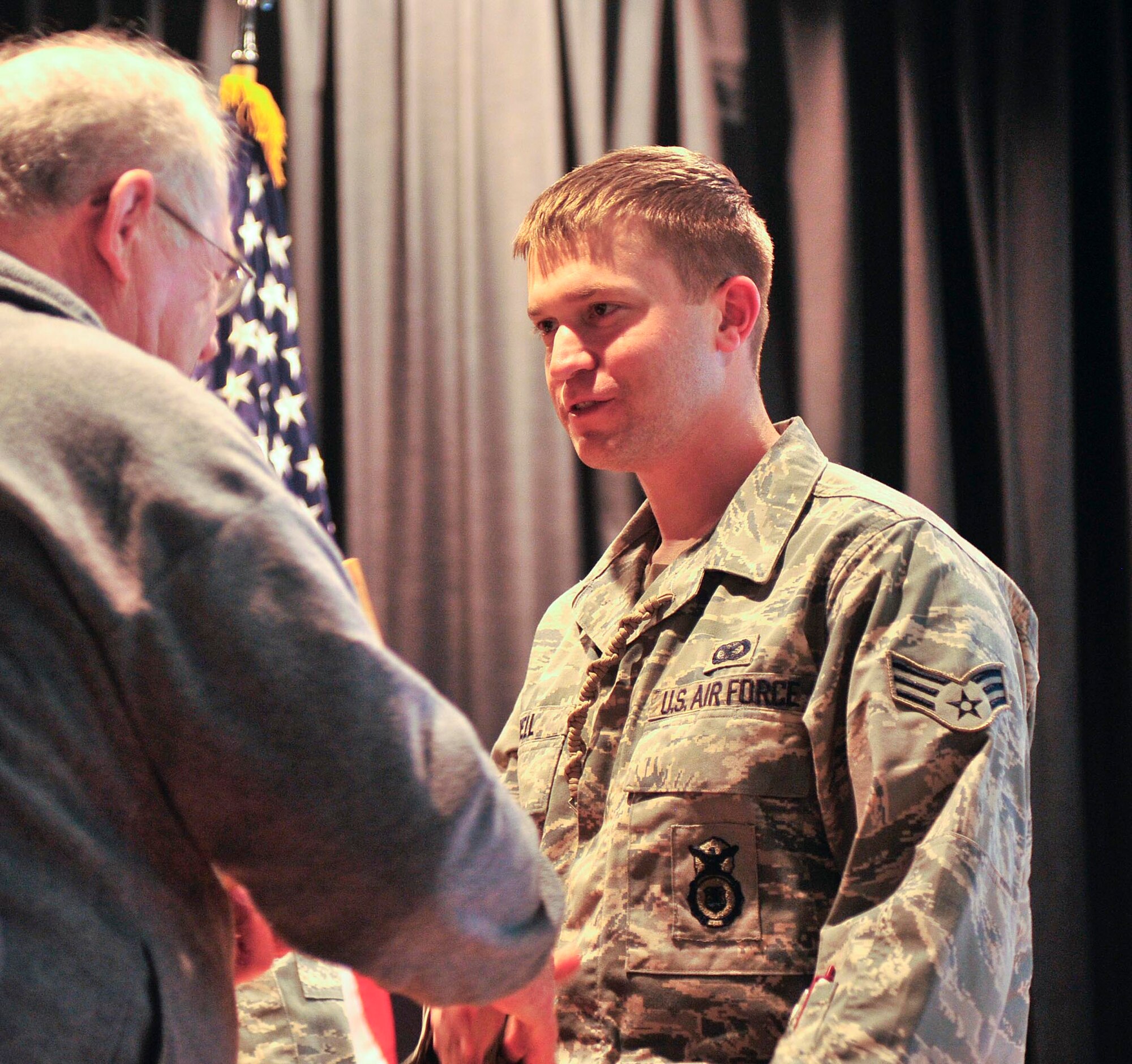 FAIRCHILD AIR FORCE BASE, Wash –Mr. Graham Crutchfield presents a commemorative Buck knife to Senior Airman Matthew Bell, 92nd Security Forces Squadron, here March 25 for his tour to Camp Bucca, Iraq. (U.S. Air Force Photo/ Senior Airman Darlene West)
