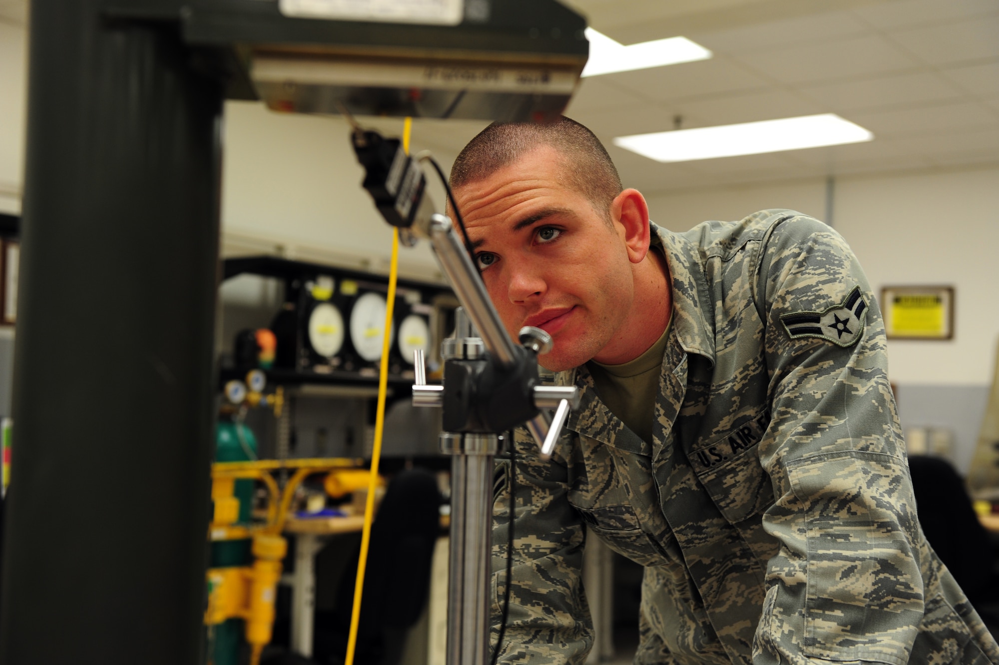 SHAW AIR FORCE BASE, S.C. -- Airman 1st Class Joseph Bain, 20th Component Maintenance Squadron equipment technician, uses a height gauge meter to check the surface of a collimator here March 30. The Precision Measurement Equipment Laboratory calibrates a wide variety of tools and equipment to ensure that the equipment is ready to use. (U.S. Air Force photo/Airman 1st Class Neil D. Warner)