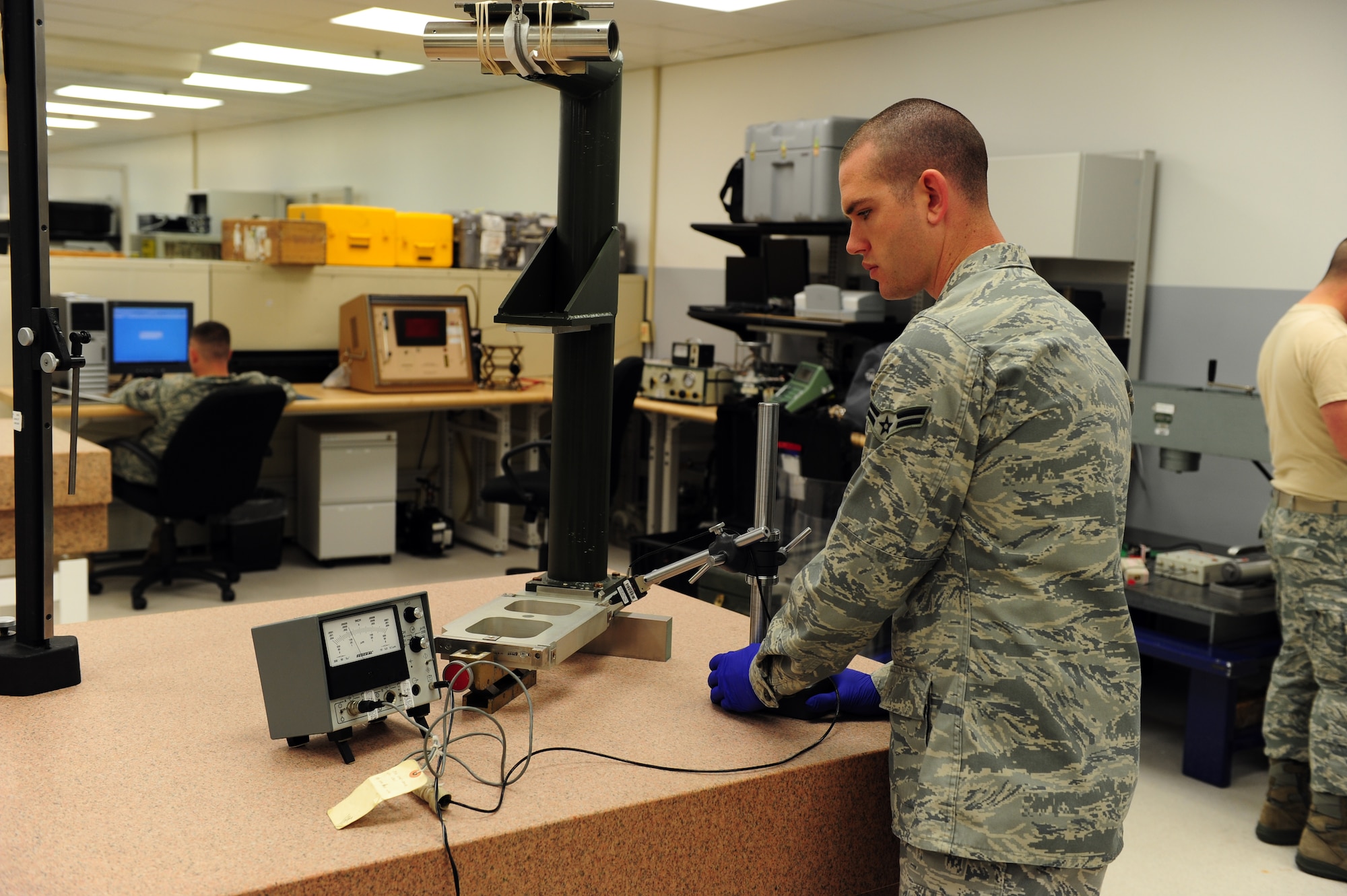 SHAW AIR FORCE BASE, S.C. -- Airman 1st Class Joseph Bain, 20th Component Maintenance Squadron equipment technician, uses a height gauge meter to check the surface of a collimator here March 30. The Precision Measurement Equipment Laboratory calibrates a wide variety of tools and equipment to ensure that the equipment is ready to use. (U.S. Air Force photo/Airman 1st Class Neil D. Warner)