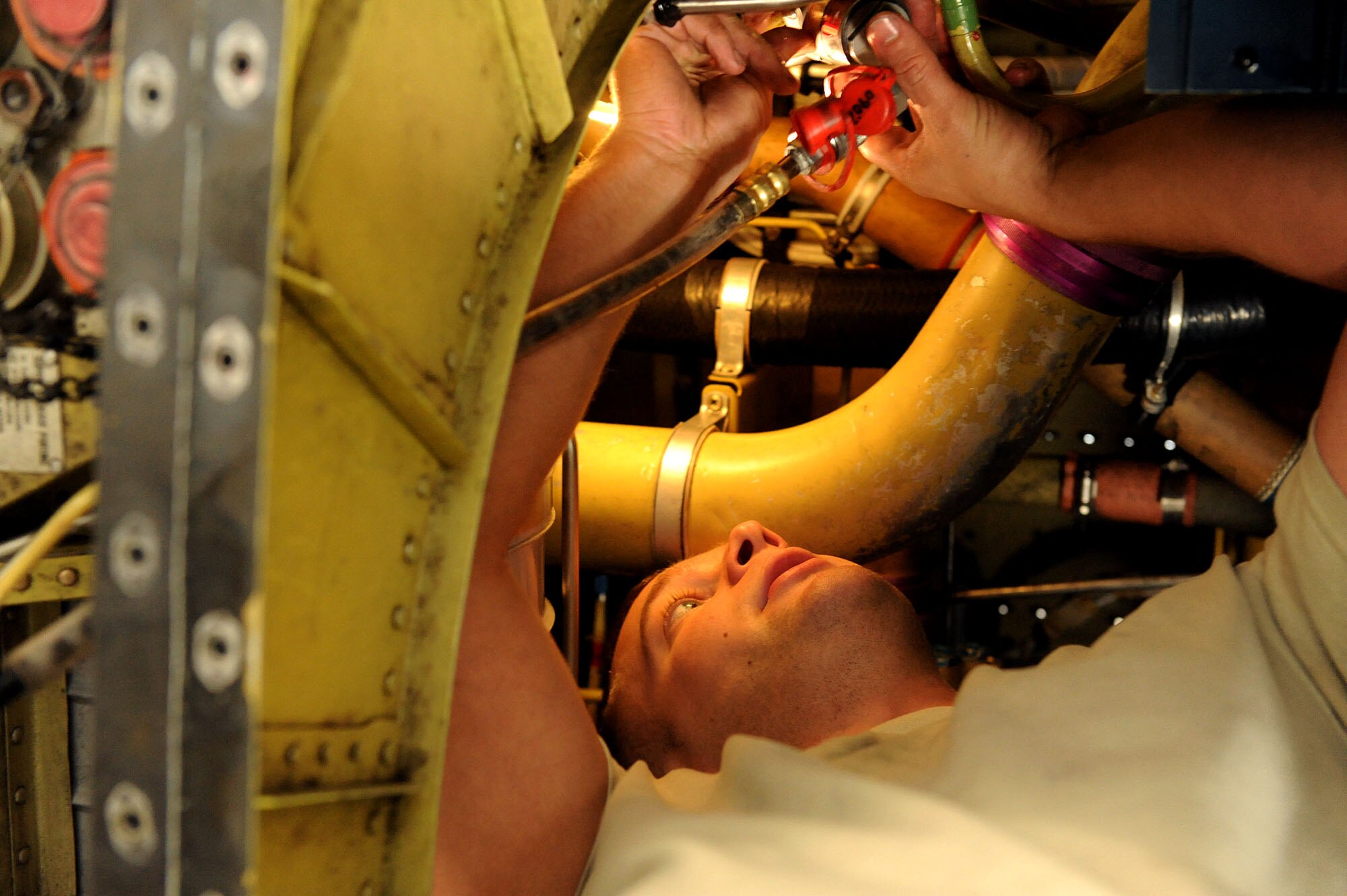 MOODY AIR FORCE BASE, Ga. -- Staff Sgt. Greg Blackburn, 23rd Equipment Maintenance Squadron, aircraft structure maintenance craftsman, replaces old hydraulic lines during an inspection on an A-10C Thunderbolt II here March 24. The hydraulic lines control a substantial amount of the aircraft’s movements and must be replaced after a leak is found in one of them. (U.S. Air Force photo by Airman 1st Class Joshua Green/RELEASED)