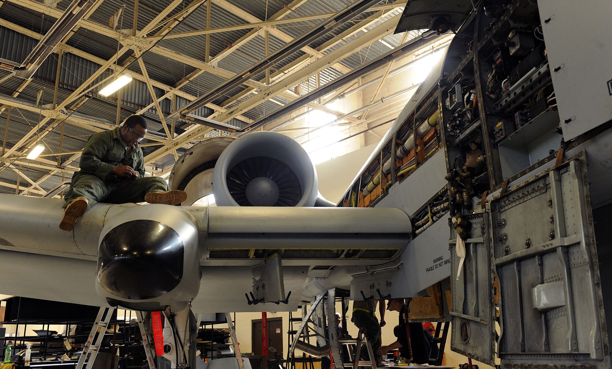 MOODY AIR FORCE BASE, Ga. -- Staff Sgt. Joseph Williams, 23rd Equipment Maintenance Squadron A-10C Thunderbolt II inspector, screws back a panel after inspecting inside the A-10C here March 24. When the panels are removed, they are required to search for debris, foreign objects, and damage to the outside and inside of the panels. (U.S. Air Force photo by Airman 1st Class Joshua Green/RELEASED)