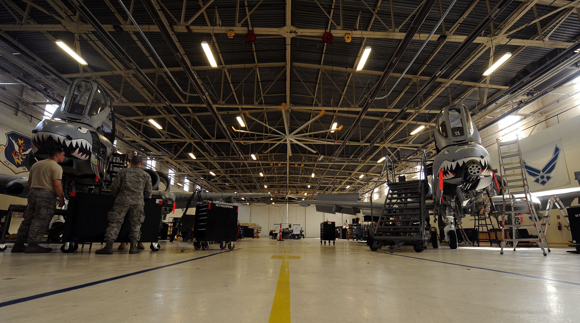 MOODY AIR FORCE BASE, Ga. -- Two A-10C Thunderbolt II aircraft sit inside the phase doc hangar for inspection here March 24. After an A-10C reaches 500 flight hours it is required to receive an in-depth inspection to ensure there are no outer or structural damage to the aircraft. (U.S. Air Force photo by Airman 1st Class Joshua Green/RELEASED)