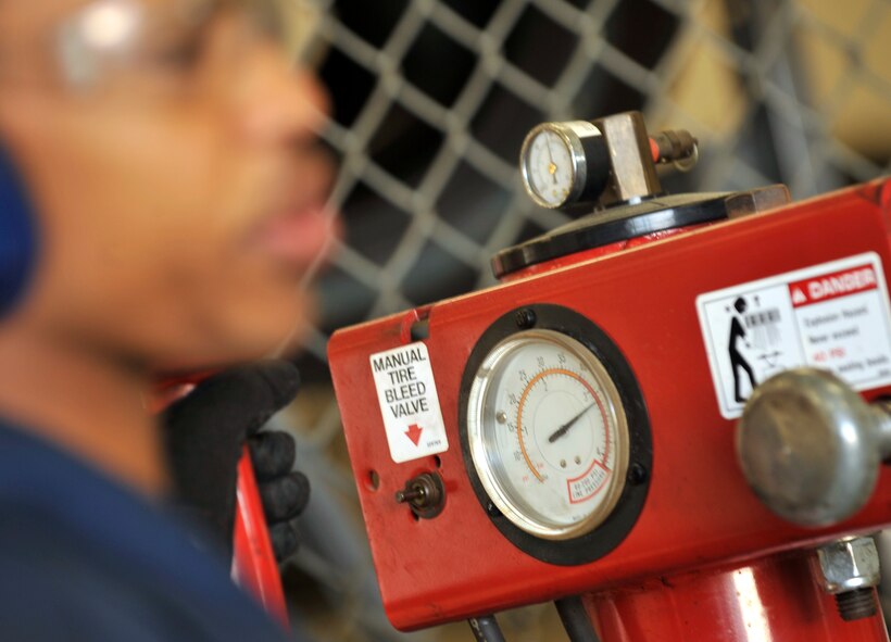 MOODY AIR FORCE BASE, Ga. -- Airman 1st Class Travias Ellison, 23rd Logistics Readiness Squadron vehicle maintenance apprentice, changes out a valve stem on a tire for an emergency response vehicle here March 29. In order to change the valve, this machine removes the weight, takes the tire off the rim and measures the pressure. (U.S Air Force photo by Staff Sgt. Schelli Jones/RELEASED)