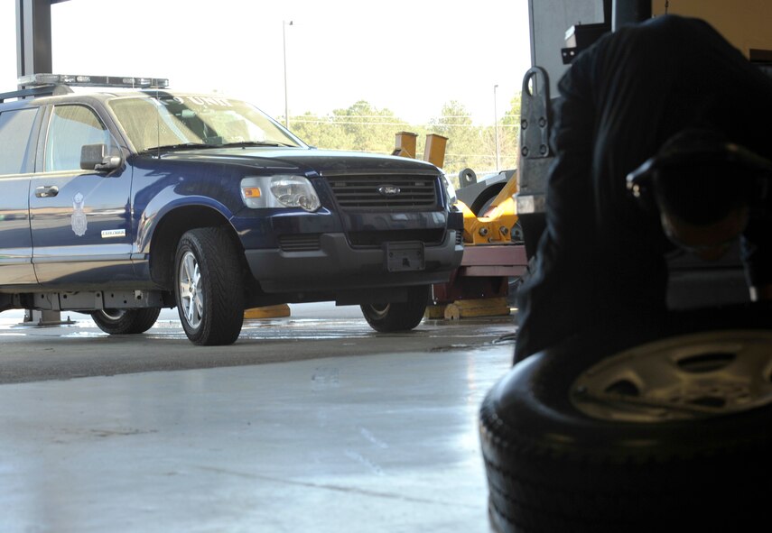 MOODY AIR FORCE BASE, Ga. -- A 23rd Security Forces Squadron emergency response vehicle waits to be repaired while Airman 1st Class Travias Ellison, 23rd Logistics Readiness Squadron vehicle maintenance apprentice, works on repairing a tire that is unserviceable here March 29. “The primary goal of this flight is to maintain a safe and serviceable fleet to help support the 23rd Wing’s mission,” said Joe Mitchell, 23rd LRS vehicle fleet manager. “Having all the emergency response vehicles prepared is obviously very important because of the wide range of effects they can have." (U.S Air Force photo by Staff Sgt. Schelli Jones/RELEASED)