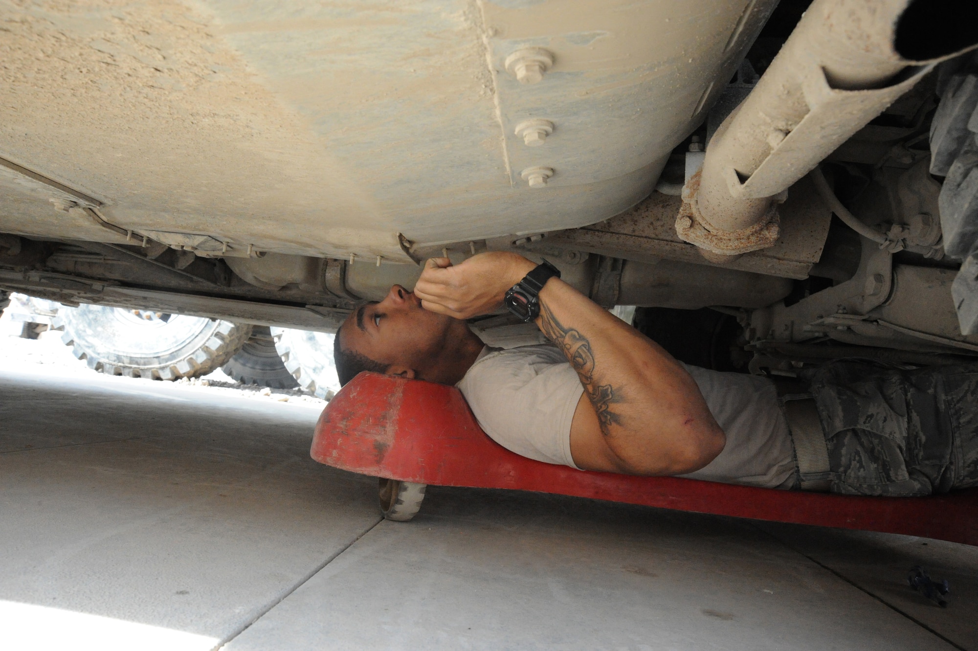 Air Force Senior Airman Juan Barnes, 732nd Expeditionary Security Forces Squadron, checks under his 1151 High Mobility Multipurpose Wheeled Vehicle for any potential mechanical problems, Camp Stryker, Iraq, March 25, 2010.  During each inspection, the “Reapers” go through a checklist that includes lubing all grease joints, and checking for vehicle fluid leaks. There is always a qualified vehicle maintainer to assist and ensure everything is done correctly. (U.S. Air Force photo/Master Sgt. Trish Bunting/Released)