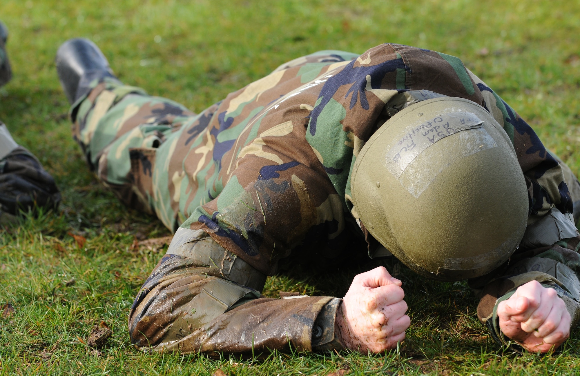 SPANGDAHLEM AIR BASE, Germany – Senior Airman Adam Fields, 52nd Component Maintenance Squadron, crawls through a wet field during individual core competency skills training April 2. The training reviewed individual chemical, biological, radiological and nuclear defense; weapon proficiency; first aid; post attack reconnaissance and fire fighting to prepare active participants in the NATO Force Evaluation this summer. (U.S. Air Force photo/Senior Airman Nathanael Callon)