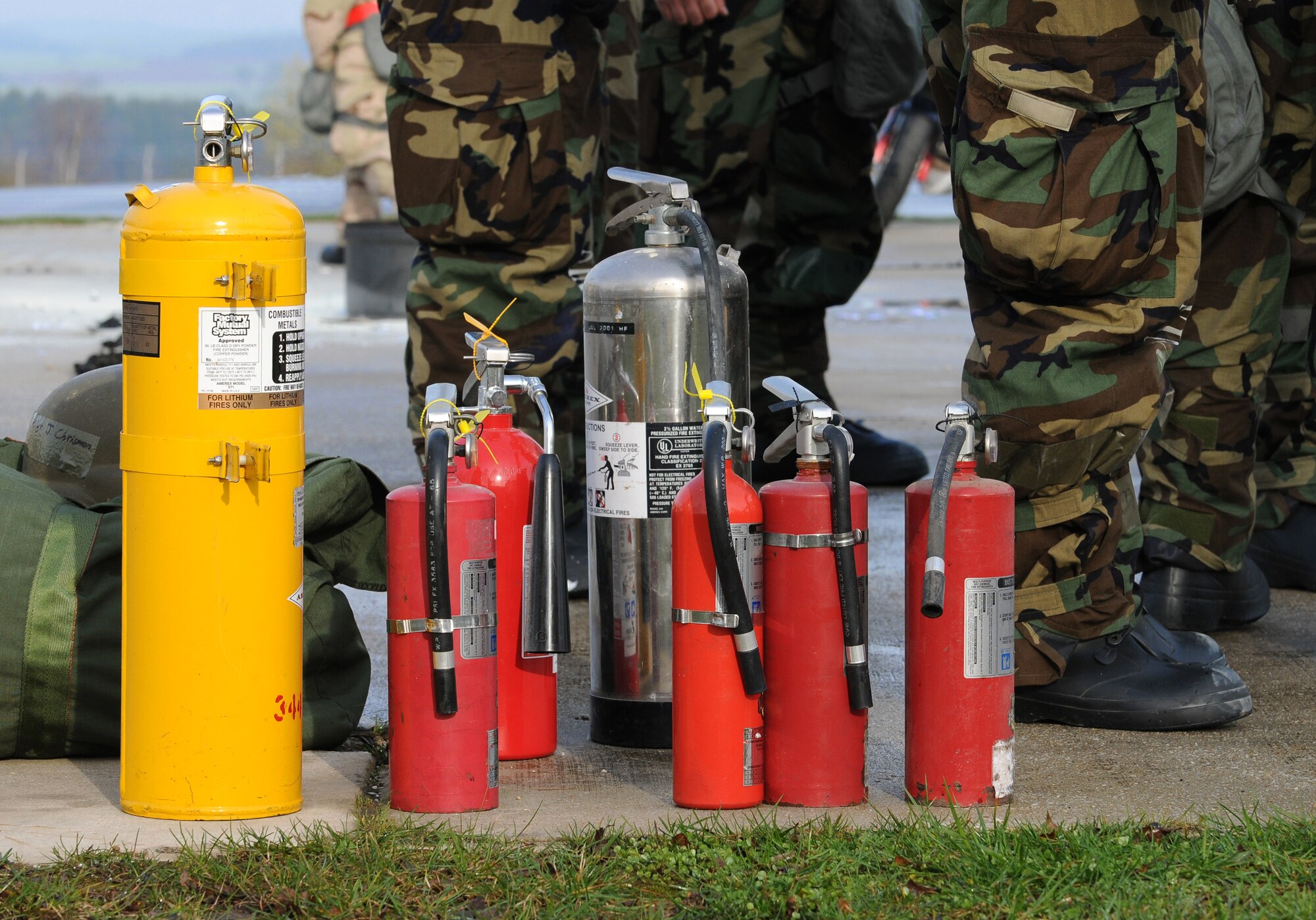 SPANGDAHLEM AIR BASE, Germany – Various classes of fire extinguishers sit on the ground during individual core competency skills training April 2. The training reviewed individual chemical, biological, radiological and nuclear defense; weapon proficiency; first aid; post attack reconnaissance and fire fighting to prepare active participants in the NATO Force Evaluation this summer. (U.S. Air Force photo/Senior Airman Nathanael Callon)