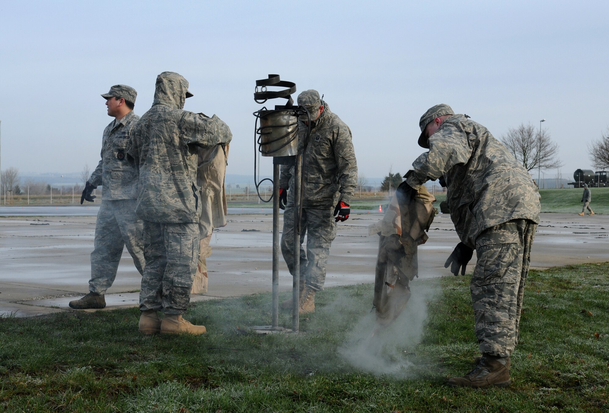 SPANGDAHLEM AIR BASE, Germany – Firefighters from the 52nd Civil Engineer Squadron replace a burnt uniform on a dummy during individual core competency skills training April 2. The training reviewed individual chemical, biological, radiological and nuclear defense; weapon proficiency; first aid; post attack reconnaissance and fire fighting to prepare active participants in the NATO Force Evaluation this summer. (U.S. Air Force photo/Senior Airman Nathanael Callon)