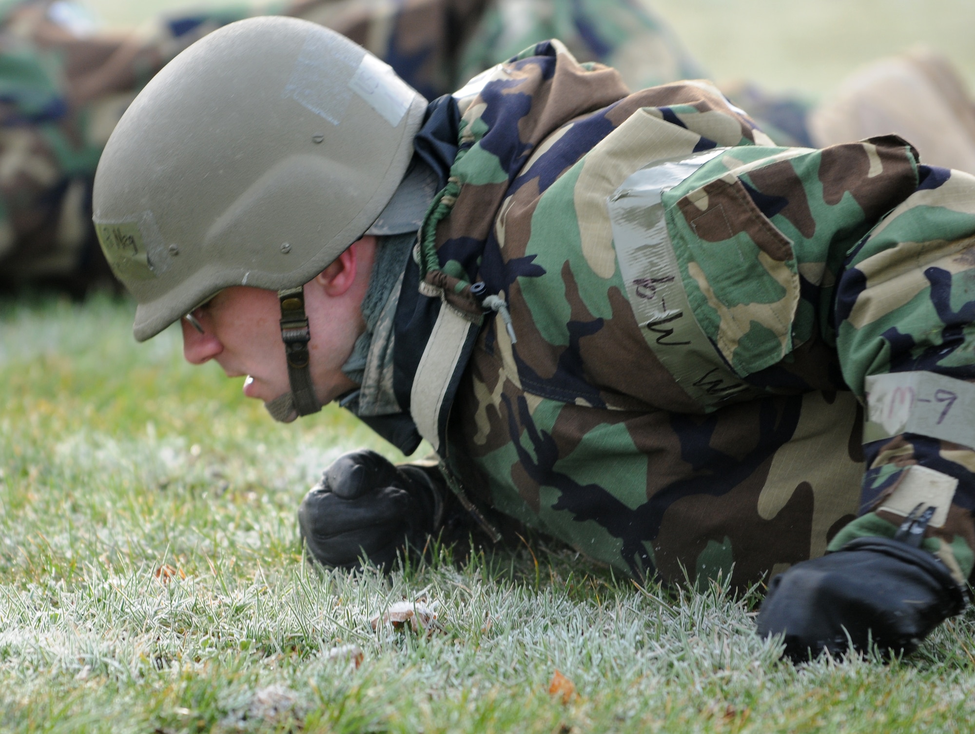 SPANGDAHLEM AIR BASE, Germany – Lt. Col. Kenneth Crane, 52nd Communications Squadron commander, low crawls across a field during individual core competency skills training April 2. The training reviewed individual chemical, biological, radiological and nuclear defense; weapon proficiency; first aid; post attack reconnaissance and fire fighting to prepare active participants in the NATO Force Evaluation this summer. (U.S. Air Force photo/Senior Airman Nathanael Callon)