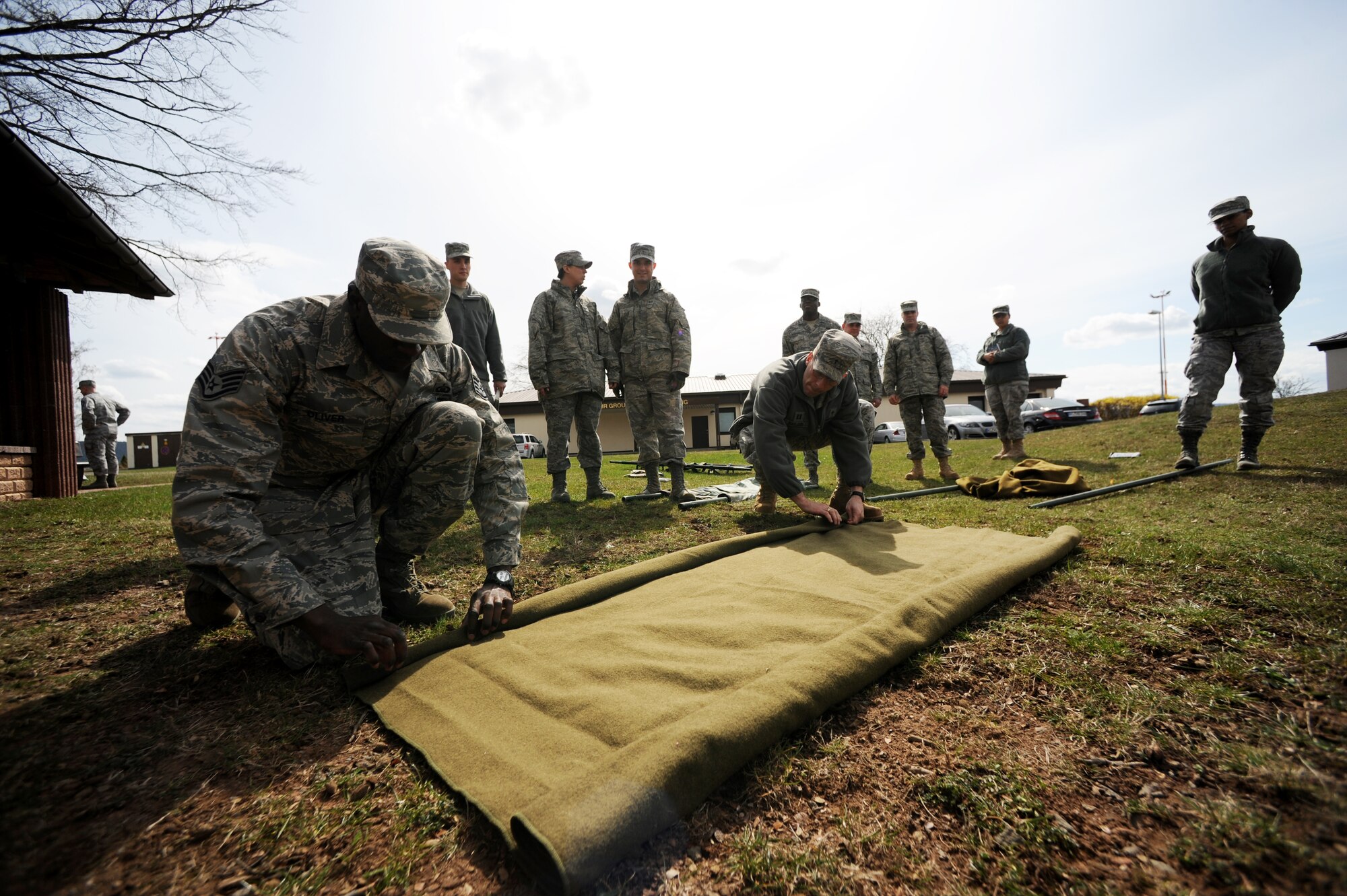 U.S. Air Staff Sgt. Karriem Oliver, 86th Airlift Wing Staff Agency, chaplain's assistant, demonstrates how to make an improvised litter during self aid and buddy care training in support of the upcoming Operations Readiness Inspection (ORI), April 2, 2010, Ramstein Air Base, Germany. Preparation for the ORI allows Air Force members to build on strengths and indentify weaknesses in order to better support future missions. (U.S. Air Force photo by Tech. Sgt. Sarayuth Pinthong)