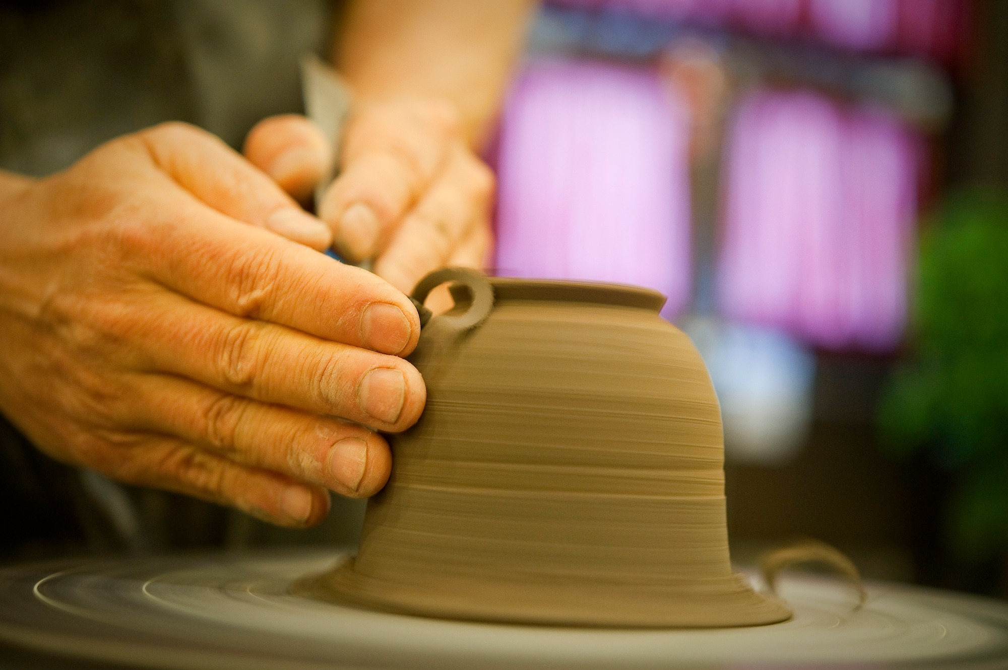MISAWA AIR BASE, Japan -- Yamamoto Harushiko, a local toin potter, carves a pot during Japan Day April 3 at the Tohoku Enlisted Club. Mr. Harushiko demonstrated the art of pot-making to American and Japanese guests. (U.S. Air Force Photo/Staff Sgt. Chad C. Strohmeyer)