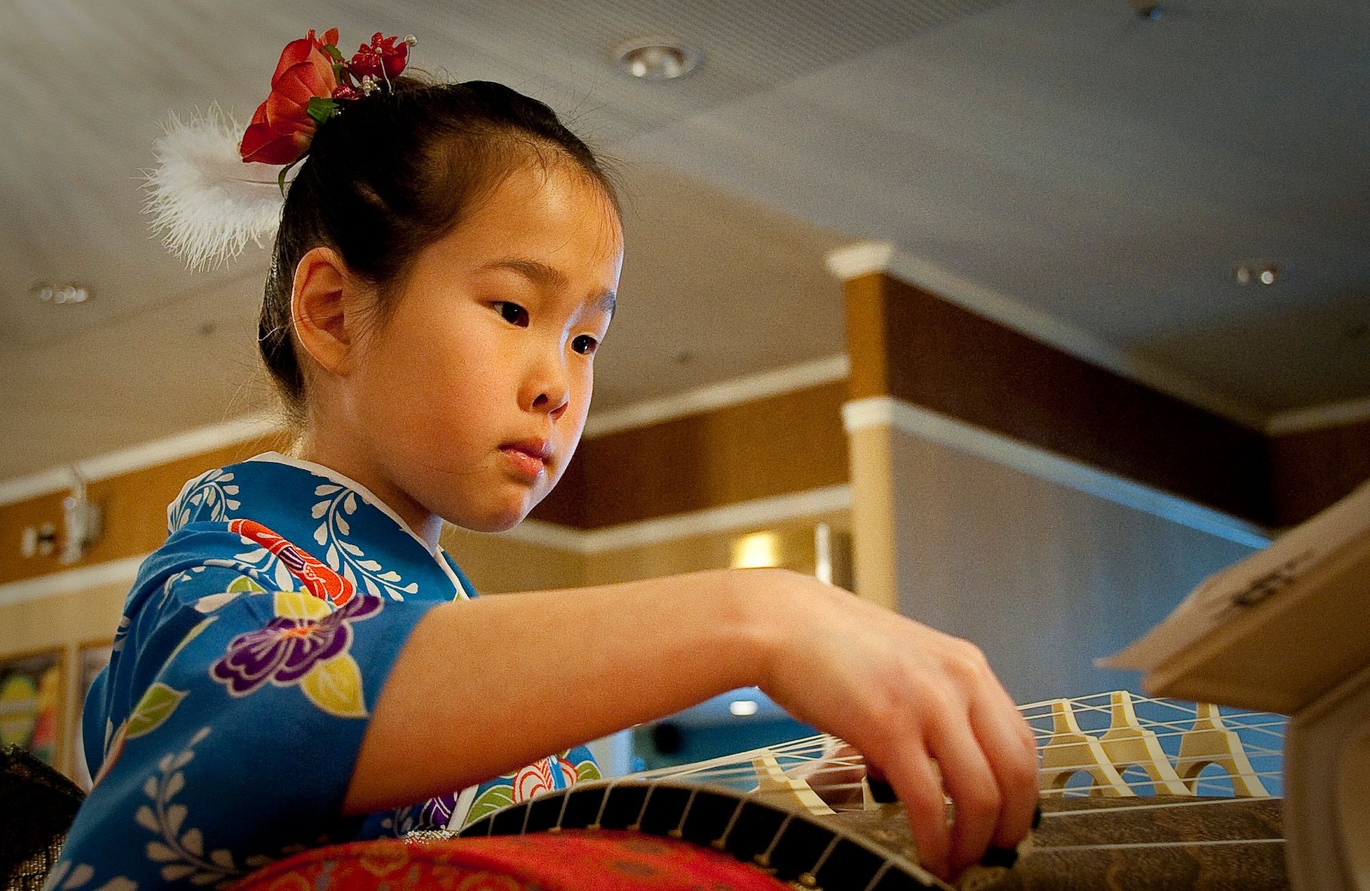 MISAWA AIR BASE, Japan -- Megumi Tanaka, a member of the Wa-Wa-Wa Club, practices on her koto before her performance during Japan Day April 3 at the Tohoku Enlisted Club. The koto is the national instrument of Japan. (U.S. Air Force Photo/Staff Sgt. Chad C. Strohmeyer)
