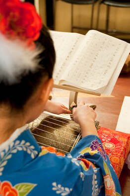 Megumi Tanaka, a member of the Wa-Wa-Wa Club, practices on her koto before her performance during Japan Day April 3, 2010, at the Tohoku Enlisted Club, Misawa Air Base, Japan. More than 600 Japanese locals visited the base to take part in the events. (U.S. Air Force photo/Staff Sgt. Chad C. Strohmeyer) 

