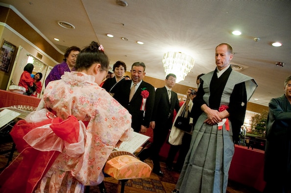 Col. David Stilwell, 35th Fighter Wing commander, and Kazumasa Taneichi, Misawa City Mayor, watch as a Japanese girl plays the koto, a traditional Japanese instrument, during Japan Day April 3, 2010, at the Tohoku Enlisted Club, Misawa Air Base, Japan. The Misawa International Club worked with volunteers from the base to bring the Japanese and American communities together. (U.S. Air Force photo/Staff Sgt. Chad C. Strohmeyer)