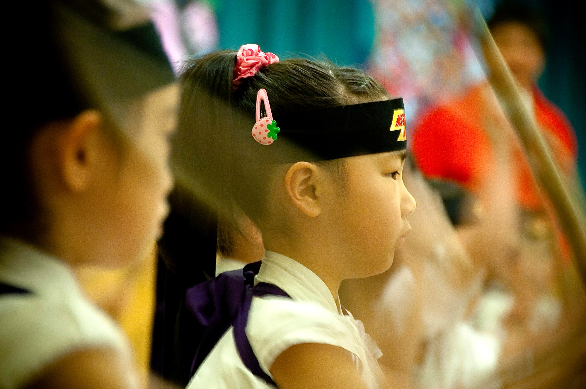 MISAWA AIR BASE, Japan -- A Japanese girl with the Makibano Drummers, plays a Taiko drum during the opening ceremony of Japan Day April 3 at the Tohoku Enlisted Club. Taiko, meaning ?great? or ?wide drum?, is a percussion instrument used for classical and traditional Japanese folk music. (U.S. Air Force Photo/Staff Sgt. Chad C. Strohmeyer) 