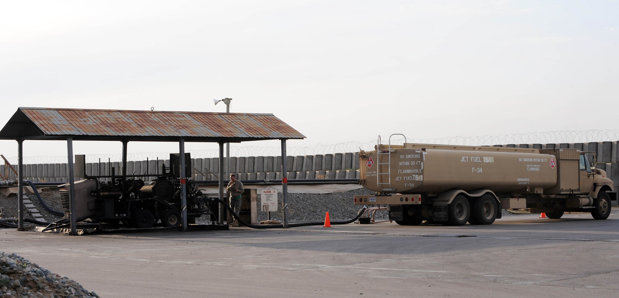 A petroleum, oil and lubricants specialist at the Transit Center at Manas, Kyrgyzstan, refills a fuel truck April 2, 2010. Fuel is issued to tankers and cargo aircraft around the clock on the flight line here, in order to keep passengers and cargo moving in and out of Afghanistan. In March, the 376th Expeditionary Logistics Readiness Squadron POL flight issued 12,500,102 gallons of gas to cargo, tanker and other combat support aircraft, "fueling the fight." (U.S. Air Force photo/Senior Airman Nichelle Anderson/released)