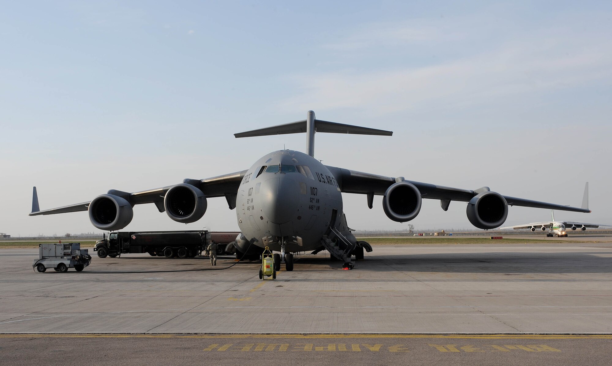 A petroleum, oil and lubricants specialist at the Transit Center at Manas, Kyrgyzstan, pumps gas from a fuel truck into a C-17 Globemaster III before its next mission to Afghanistan April 2, 2010. In March, the 376th Expeditionary Logistics Readiness Squadron POL flight issued 12,500,102 gallons of gas to cargo, tanker and other combat support aircraft, "fueling the fight." (U.S. Air Force photo/Senior Airman Nichelle Anderson/released)