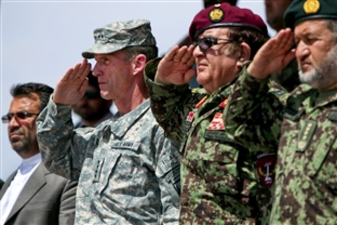 U.S. Army Gen. Stanley A. McChrystal, commander of International Security Assistance Force and U.S. Forces in Afghanistan, and Gen. Abdul Rahim Wardak, the Afghanistan Defense Minister, salute during the activation ceremony for the Afghan National Army 215th Maiwand Corps on Camp Shorabak in Helmand province, Afghanistan, April 1, 2010. Gulab Mangal, left, the governor of Helmand province, watches. The 215th Corps is the largest of its size to be formed in more than six years. 