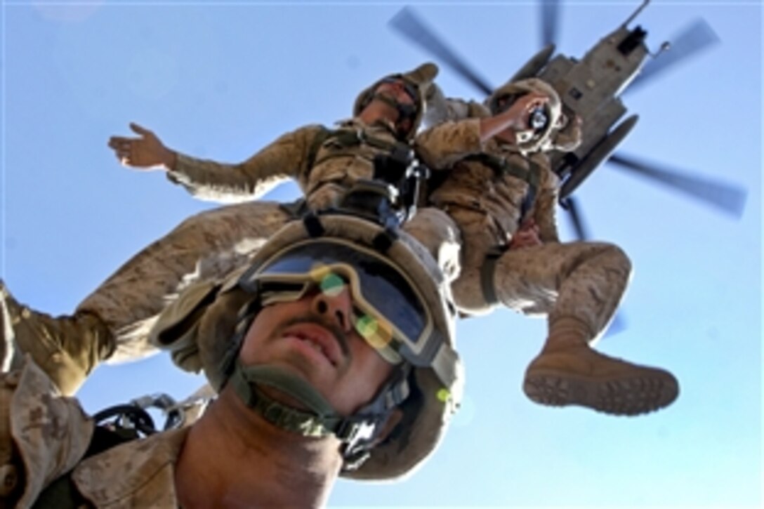 U.S. Marines remain suspended from a CH-53 Super Stallion helicopter during a special insertion and extraction exercise in Djibouti, March 24, 2010. The Marines are assigned to the 24th Marine Expeditionary Unit. Various non-infantry Marines received the opportunity to participate in the exercise for the first time.