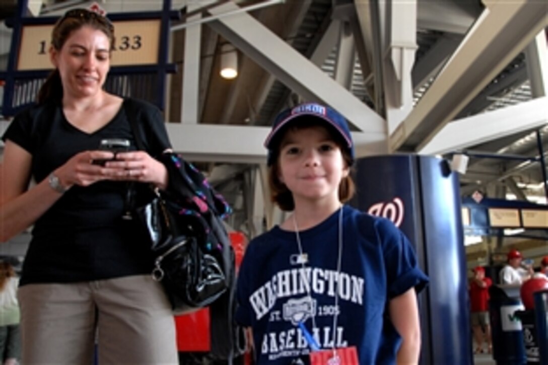 Morgan Lewis, whose mother, Jeannie Lewis, is on active duty with the U.S. Coast Guard, gets ready to head down to the field at Nationals Park in Washington D.C., April 5, 2010. Morgan was part of the “Starting Nine," a group of nine military children with family members either recently or currently deployed invited to take the field with the Washington Nationals' nine starters on opening day of the Major League Baseball season. The Nationals lost 11-1 to the Philadephia Phillies.