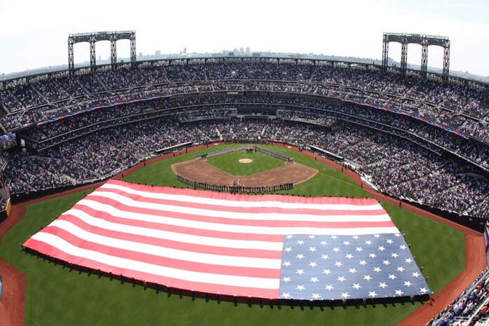 Soldiers, sailors, airmen and Marines participate in the Met's 2010 season opener, unveiling the American flag at Citi Field April 5. Marines with 1st Marine Corps District, 2nd Battalion, 25th Marines and 6th Communications Battalion joined other service members from the area to participate in the event.