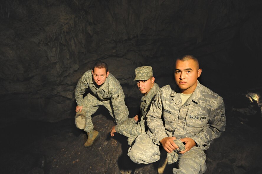 ANDERSEN AIR FORCE BASE, Guam -- Airman 1st Class Mark Gregg, Airman 1st Class Kylle Krzywiecki and Airman 1st Class Caleb Rodriguez, all from the 36th Munitions Squadron, pose in the cave where they saved a drowning man, March 27. The man, Mr. Christensen Kimi, from the island of Chuuk, survived and was released in good health from the hospital a day and a half after the Airmen pulled him from an underwater cave, performed CPR, and helped emergency services evacuate him to the hospital. (U.S. Air Force photo by Tech. Sgt. Mike Andriacco)