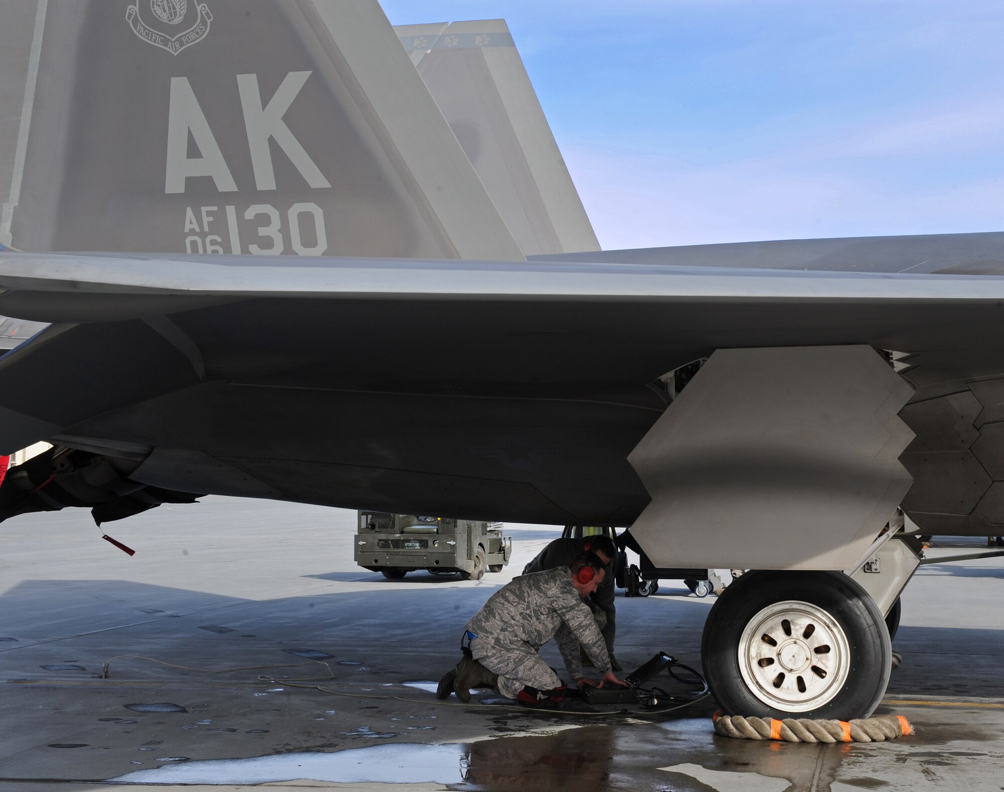 ELMENDORF AIR FORCE BASE, Alaska -- Staff Sgt. Richard Howard uses a portable maintenance aid to verify that an F-22 launcher is fully retracted during a load competition April 2. According to Master Sgt. Donald Flournoy, load competitions increase load crew efficiency and build a sense of camaraderie for weapons troops. Sergeant Howard is an aircraft armament specialist with the 525th Aircraft Maintenance Unit. (Air Force photo by Senior Airman Cynthia Spalding)