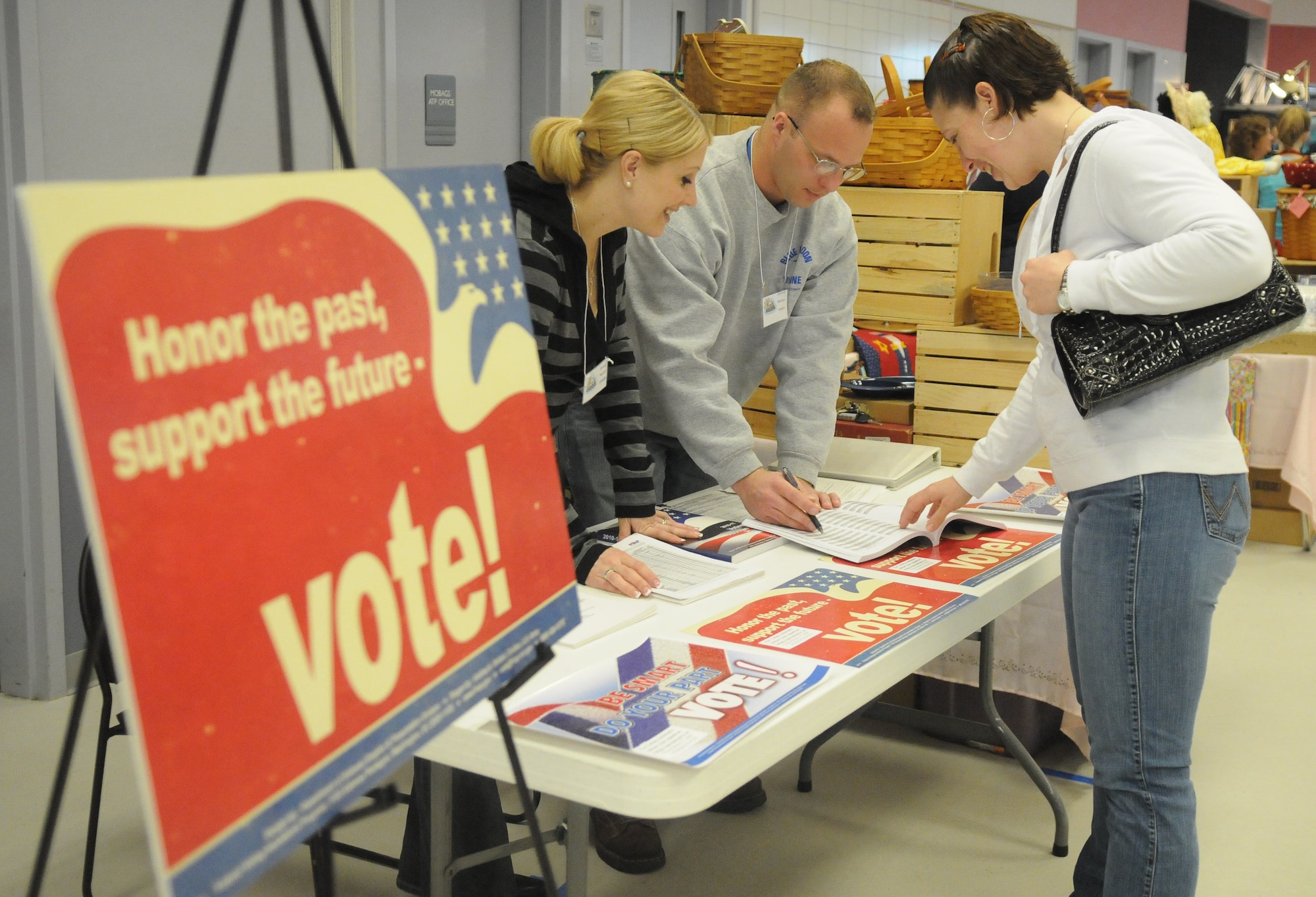 Voting booth attendants show Tech. Sgt. Rebekah Virtue voting literature at the Spouses' Club Spring Bazaar March 27, 2010, Eielson Air Force Base. The booth attendants were available to get people registered to vote and answer any questions they might have. Sergeant Virtue is a 354th Medical Group Family Practice NCO in charge.(U.S. Air Force photo by/Airman 1st Class Janine Thibault)
