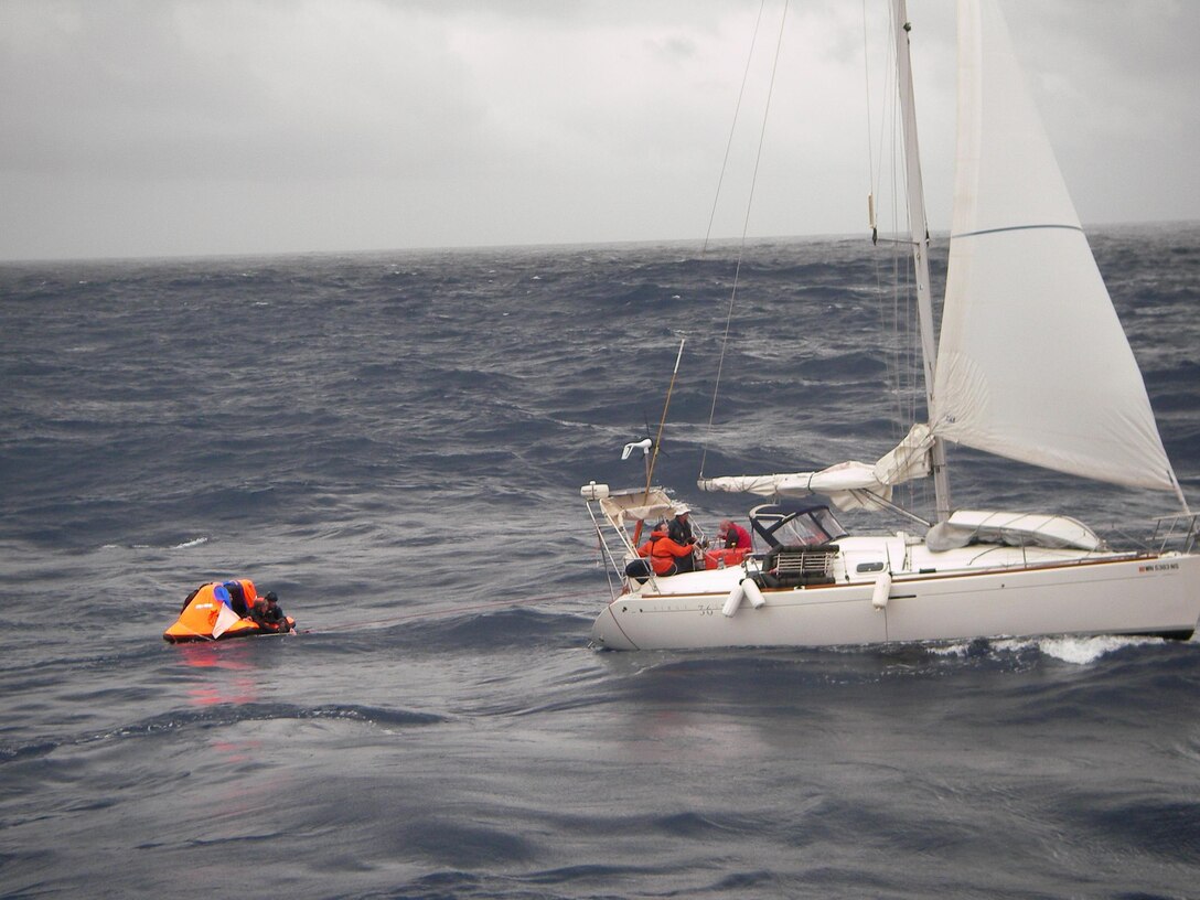 Pararescuemen from the 129th Rescue Wing transfer a patient from a sailboat to a small raft in preparation for transfer to a container vessel April 2, 2010. The Eleventh Coast Guard District Rescue Coordination Center used their Automated Mutual Assistance Vessel Rescue system to divert a Liberian registered merchant vessel, the CAP PALMERSTON, enroute to Ensenada, Mexico, to rendezvous with the sailing vessel and pick-up the PJs and their patient. The AMVER program is sponsored by the U.S. Coast Guard and is a voluntary global ship reporting system used worldwide by search and rescue authorities to arrange for assistance to persons in distress at sea. Following the transfer of the patient and PJs from the small sailboat to the CAP PALMERSTON, the ship set course to San Diego. The patient and PJs were picked up by 129th rescue crews April 4, 2010. (Photo courtesy of the CAP PALMERSTON crew.)