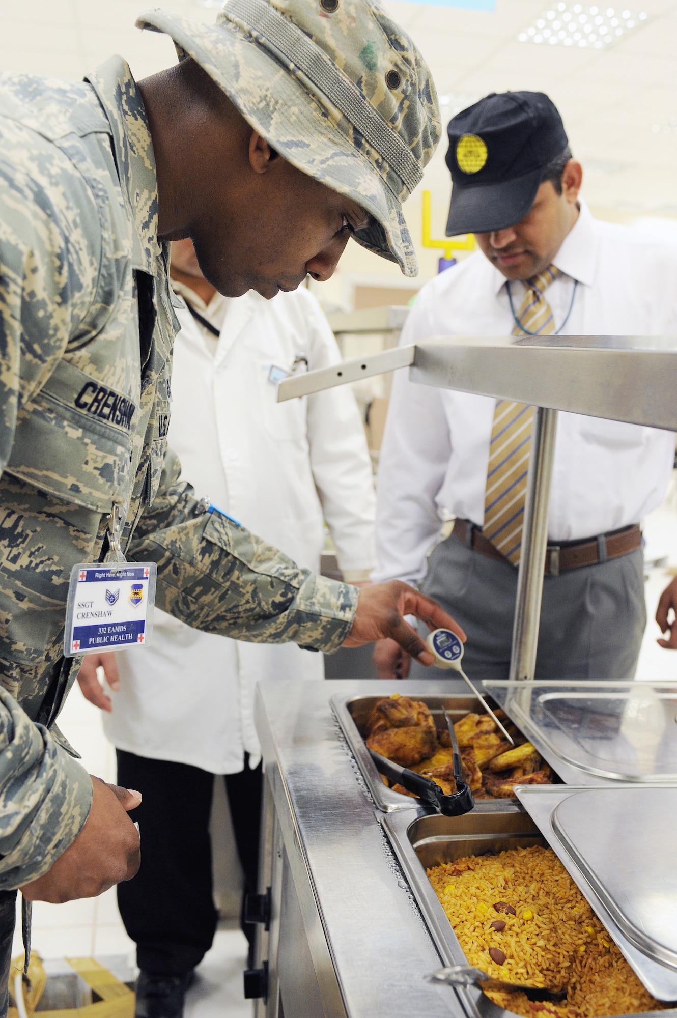 Staff Sgt. William Crenshaw checks the temperature of the chicken being served in the grab-and-go line during an inspection of Dining Facility Two March 23, 2010, at Joint Base Balad, Iraq. Sergeant Crenshaw is the 332nd Aerospace Medical Squadron public health noncommissioned officer in charge. He is deployed from Lackland Air Force Base, Texas. (U.S. Air Force photo/Master Sgt. Linda C. Miller)