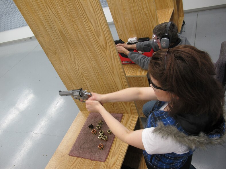 MINOT, N.D. -- 2nd Lt. Kidron B. Vestal, 5th Bomb Wing deputy chief of public affairs, shoots a revolver at an indoor shooting range following proper instruction April 5. The lesson was to expose the new shooter to firearm self defense measures. (U.S. Air Force photo by 2nd Lt. John B. Farnell)