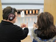 MINOT, N.D. -- 2nd Lt. Kidron B. Vestal, 5th Bomb Wing deputy chief of public affairs, receives instruction on proper pistol grip from Erik Lehner, board member for the Minot Rifle and Pistol Club April 5. (U.S. Air Force photo by 2nd Lt. John B. Farnell)