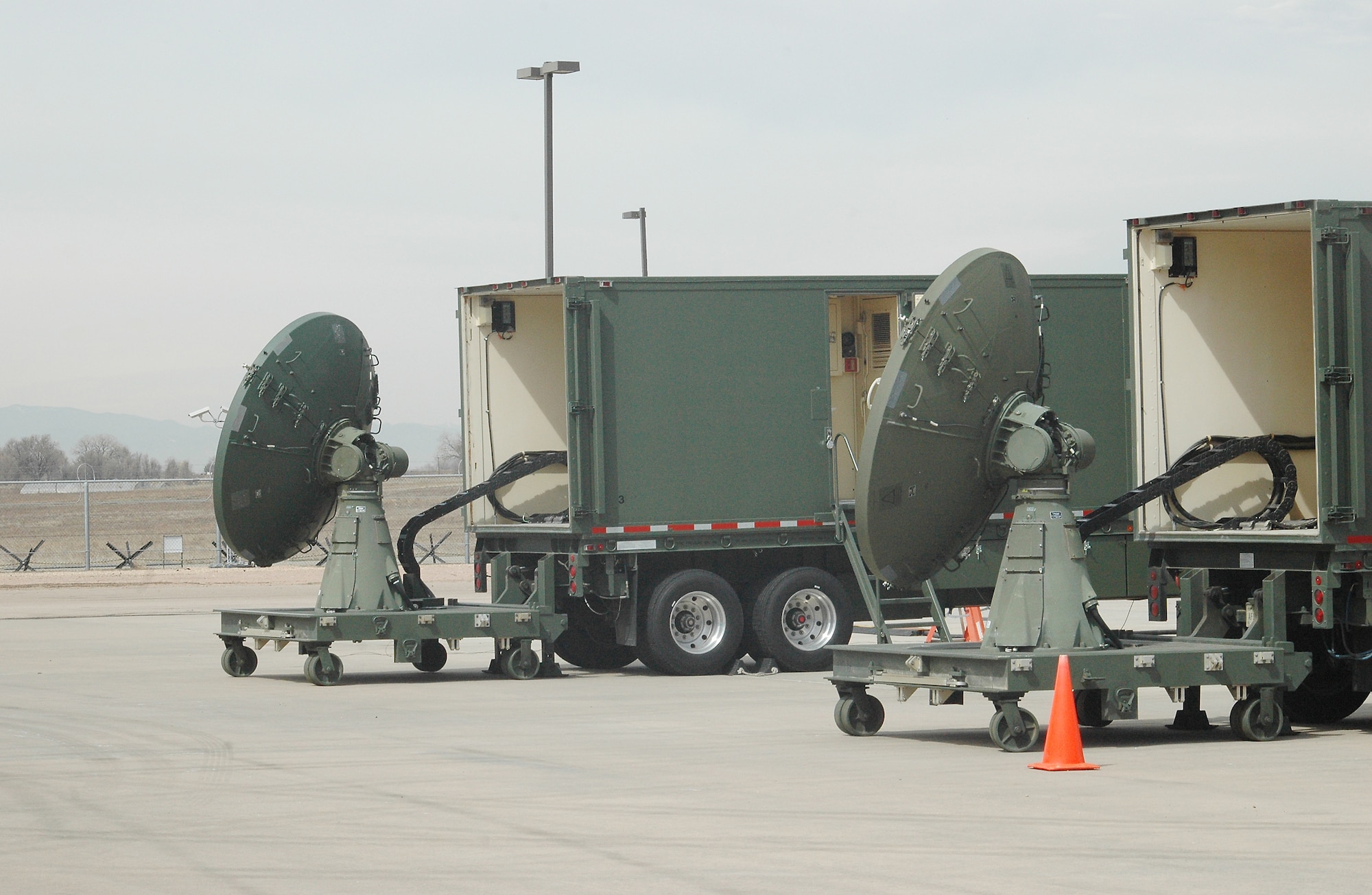 Maj. Jarrod Moseley and Capt. Stephanie Myers, 137th Space Warning Squadron, use the AN/TSQ-180 MILSTAR communications van to provide mobile missile warning and nuclear detonation detection messages to Unified Commands and the Chairman, Joint Chiefs of Staff. The Greeley Air National Guard officers comprise the Operations Team for the 460th Space Wing during Guardian Challenge. (U.S. Air Force photo by Tech. Sgt. Scott McNabb)