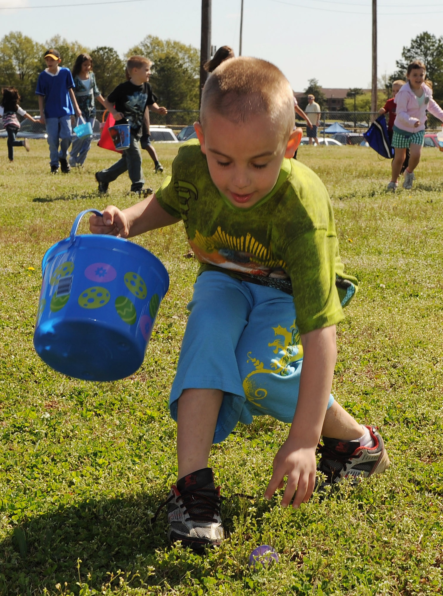 Jared Richardson, 8, son of Dustin Richardson and Tech. Sgt. Jamie Richardson, 19th Air Medical Squadron NCO-in-charge of flight medical records, picks up one of the many eggs placed over an open field for children to collect during the “It’s All About YOUth” festival and egg hunt April 3. The festival is to recognize the sacrifices made by military children of parents who are serving our country. (U.S. Air Force photo by Staff Sgt. Chad Chisholm)