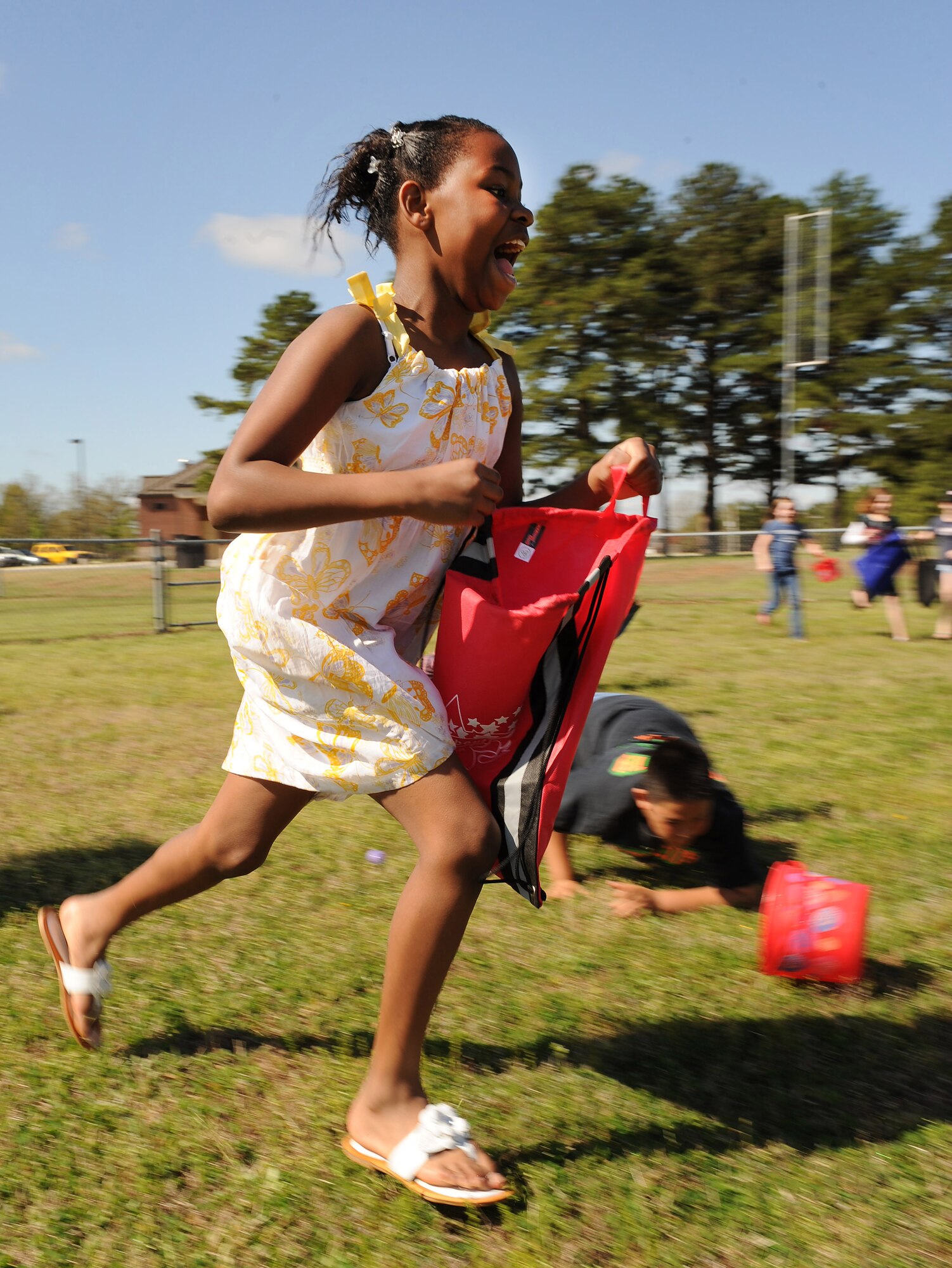 Gabriella Reed, 10, daughter of Nicholasa Reed, 19th Force Support Squadron commercial sponsorship coordinator, runs across the open field trying to collect as many eggs as possible during the “It’s All About YOUth” festival and egg hunt April 3. Miss Reed, along with more than 500 base children, attended the festival for Month of the Military Child at Little Rock Air Force Base. (U.S. Air Force photo by Staff Sgt. Chad Chisholm)