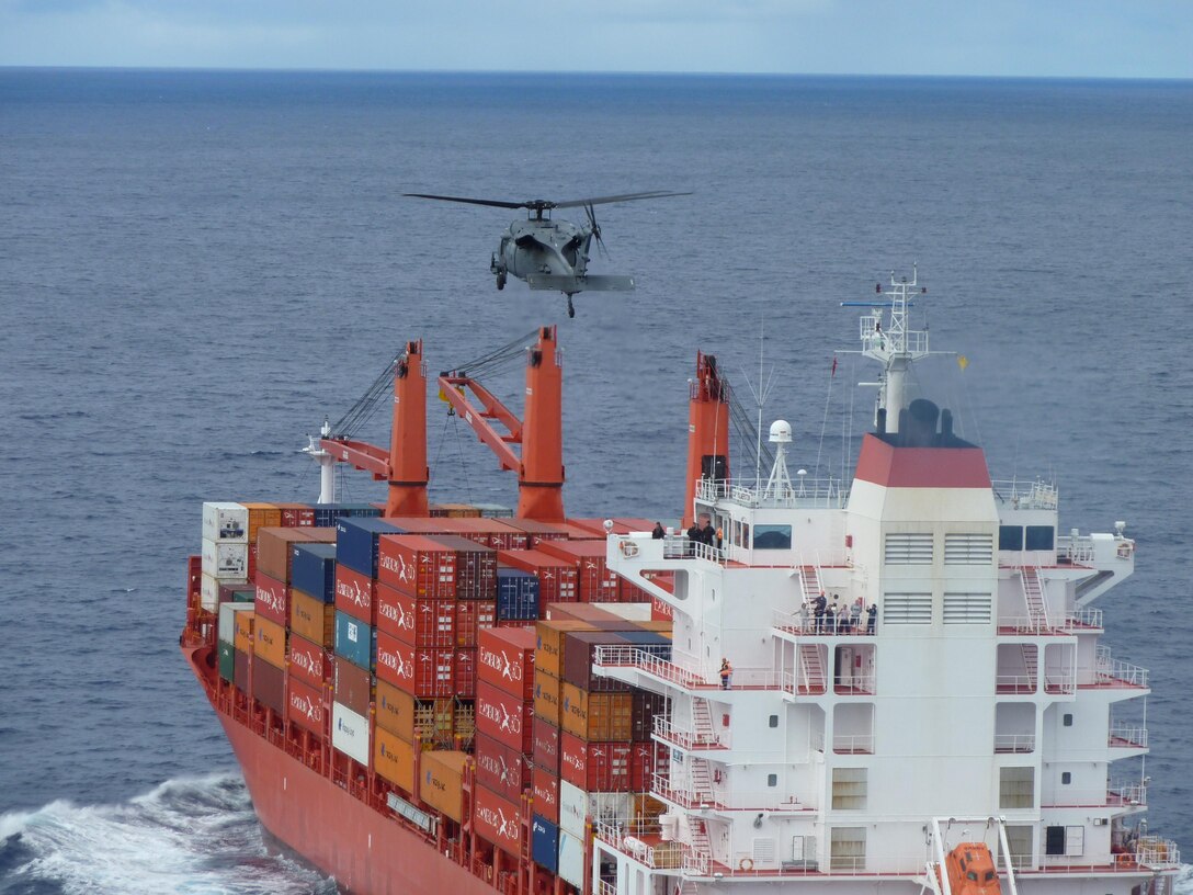 A 129th Rescue Wing HH-60G Pave Hawk rescue helicopter maneuvers towards a container ship during a rescue mission 650 miles off the coast of Baja, Mexico, April 4, 2010. The 129th sent two HH-60G Pave Hawk rescue helicopters and one MC-130P Combat Shadow aircraft, accompanied by one Marine Corps KC-130J Super Hercules tanker from Marine Corps Air Station Miramar, to pick up Michael Kalahar, a 56-year-old sailor from Port Angeles, Wash., who suffered life-threatening head and neck injuries aboard his sailing vessel WIND CHILD. The 129th rescue aircraft also recovered a four-man pararescue team, also based with the 129th. (Photo courtesy of Staff Sgt. Andrew Gibson) 