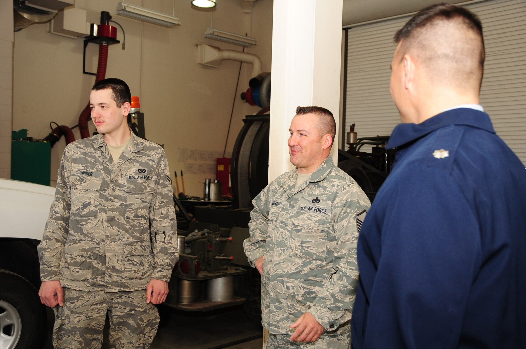 ELLSWORTH AIR FORCE BASE, S.D. -- (Left to right) Airman 1st Class Donald Grider, 28th Civil Engineer Squadron electrical power technician and Master Sgt. David Komandt, 28 CES NCO in charge of electrical power production, discuss generator functions and requirements with  Lt. Col. Matthew Joganich, 28 CES commander, April 5.  Without electricity and power, Airmen on base cannot complete their mission, making the electrical power production a mission enabler for the entire 28th Bomb Wing. (U.S. Air Force photo/Airman 1st Class Anthony Sanchelli)