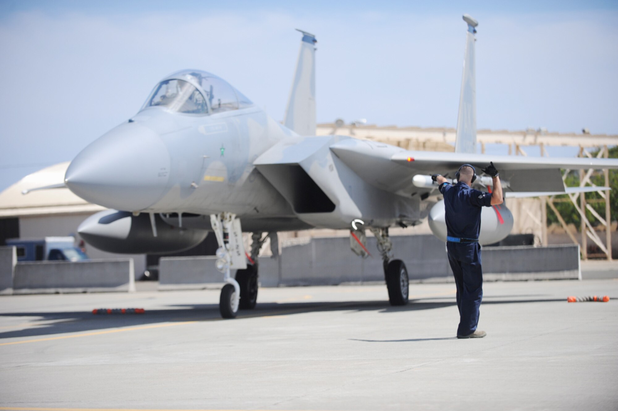 Senior Airman Dallion Griffin signals to a 19th Fighter Squadron pilot that pre-checks are complete and that he can taxi out to the runway for takeoff to participate in a training exercise March 23, 2010 at Joint Base Pearl Harbor-Hickam, Hawaii. Airman Griffin is an F-15 Eagle crew chief with the 19th Aircraft Maintenance Unit, 3rd Maintenance Squadron at Elmendorf Air Force Base, Alaska. (U.S. Air Force photo/Tech. Sgt. Cohen A. Young)