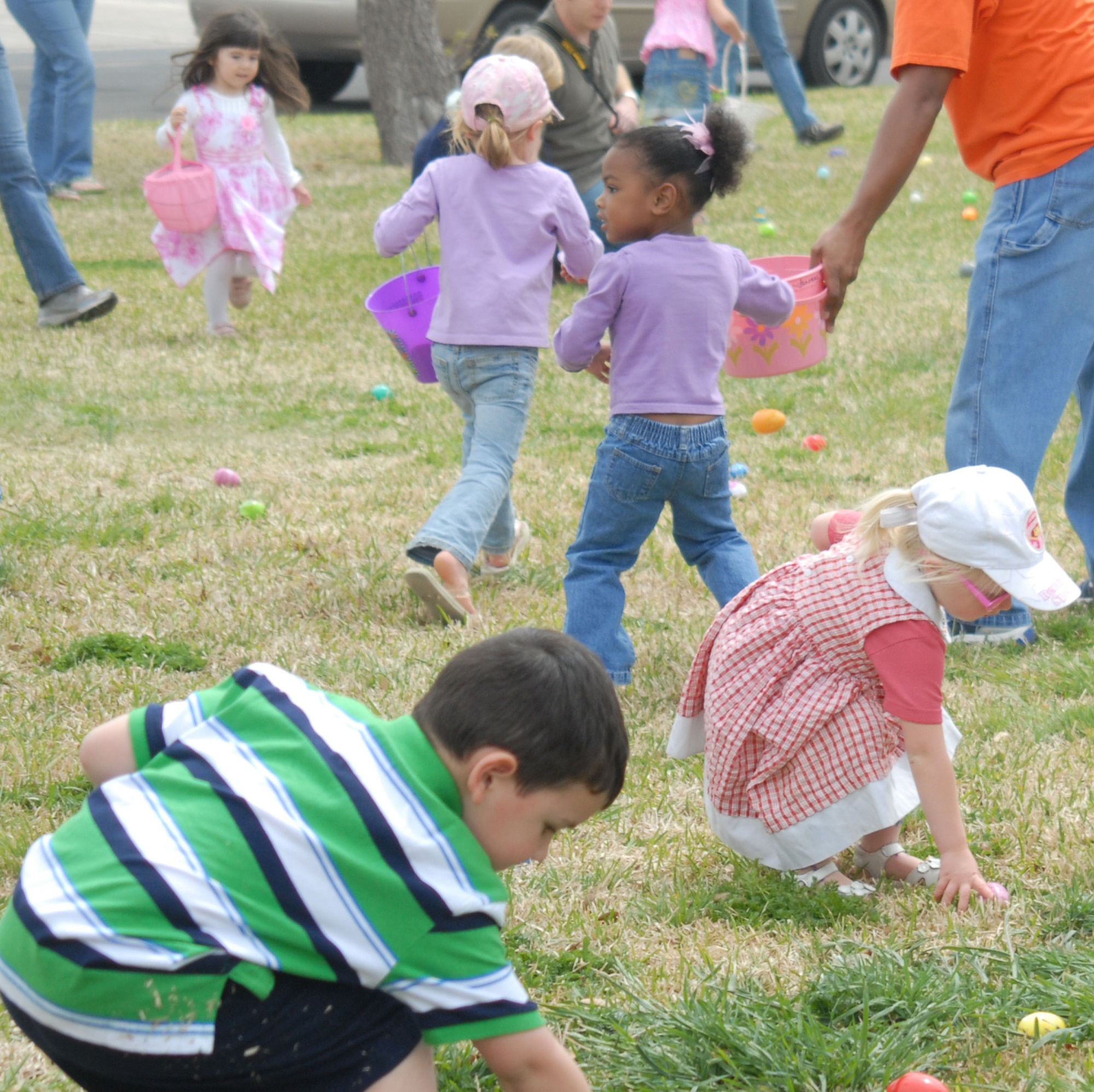 Children rush to fill their baskets with eggs, during the Base Wide Egg Hunt, April 3, at Goodfellow. (U.S. Air Force photo/Airman 1st Class Anne Gathua )