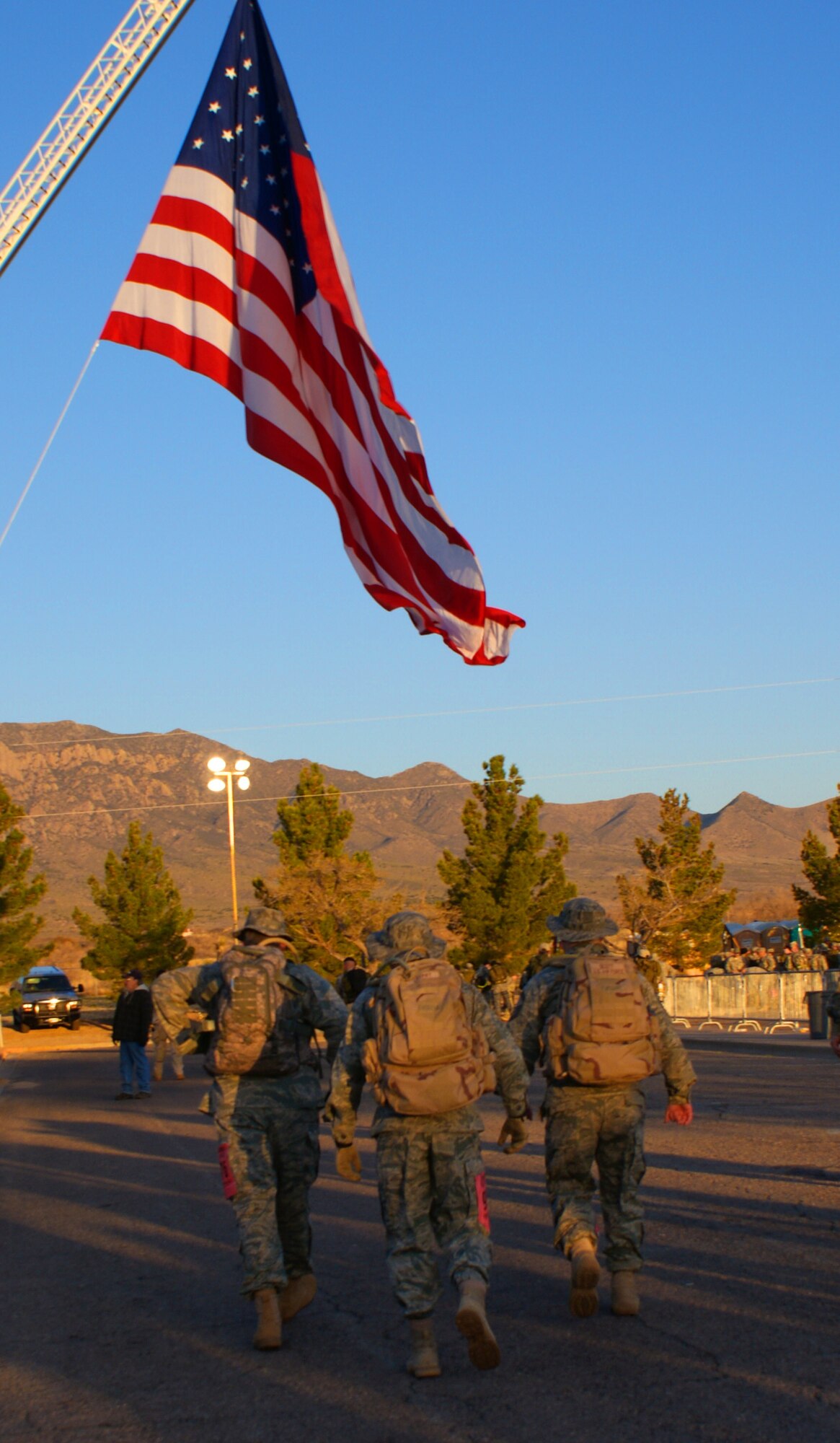Lt. Col. Paul Tombarge, left, the commander of the 16th Space Control Squadron, Chief Master Sgt. Robert Cherry, center, squadron superintendent for the 380th Space Control Squadron, and Senior Master Sgt. Jeffery Scott, operations superintendent for the 380th Space Control Squadron, walk to the starting line before beginning the 2010 Bataan Memorial Death March.