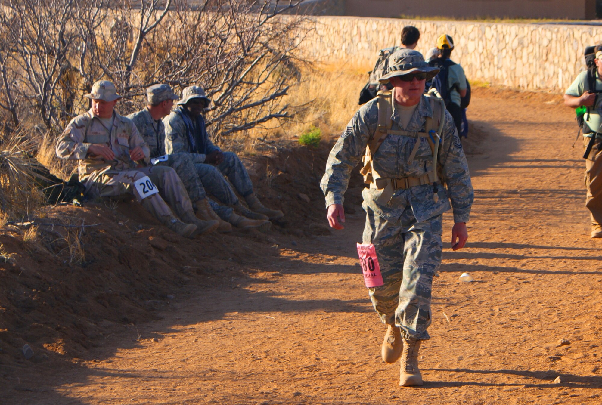 Chief Master Sgt. Robert Cherry, squadron superintendent for the 380th Space Control Squadron, nears the finish line at the 2010 Bataan Memorial Death March, with his 45-pound rucksack of assorted beans. Chief Cherry completed the 26.2 mile course in a little more than 10 hours.