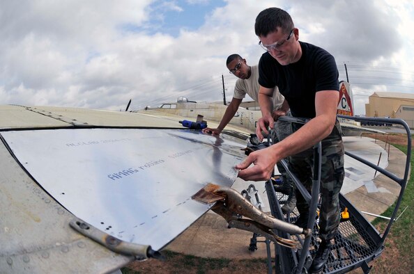 BARKSDALE AIR FORCE BASE, La. -- Airmen 1st Class Bronson Bohannon (right) and Avondries Green, 2d Maintenance Squadron aircraft structural maintainers, install rivets on new sheet metal wing flaps April 5. The Airmen are assisting, along with other Barksdale Airmen, volunteers and contractors, with the restoration of a B-17 aircraft in honor of Maj. Gen. Lewis E. Lyle who was a World War II combat pilot. (U.S. Air Force photo by Staff Sgt. John Gordinier)
