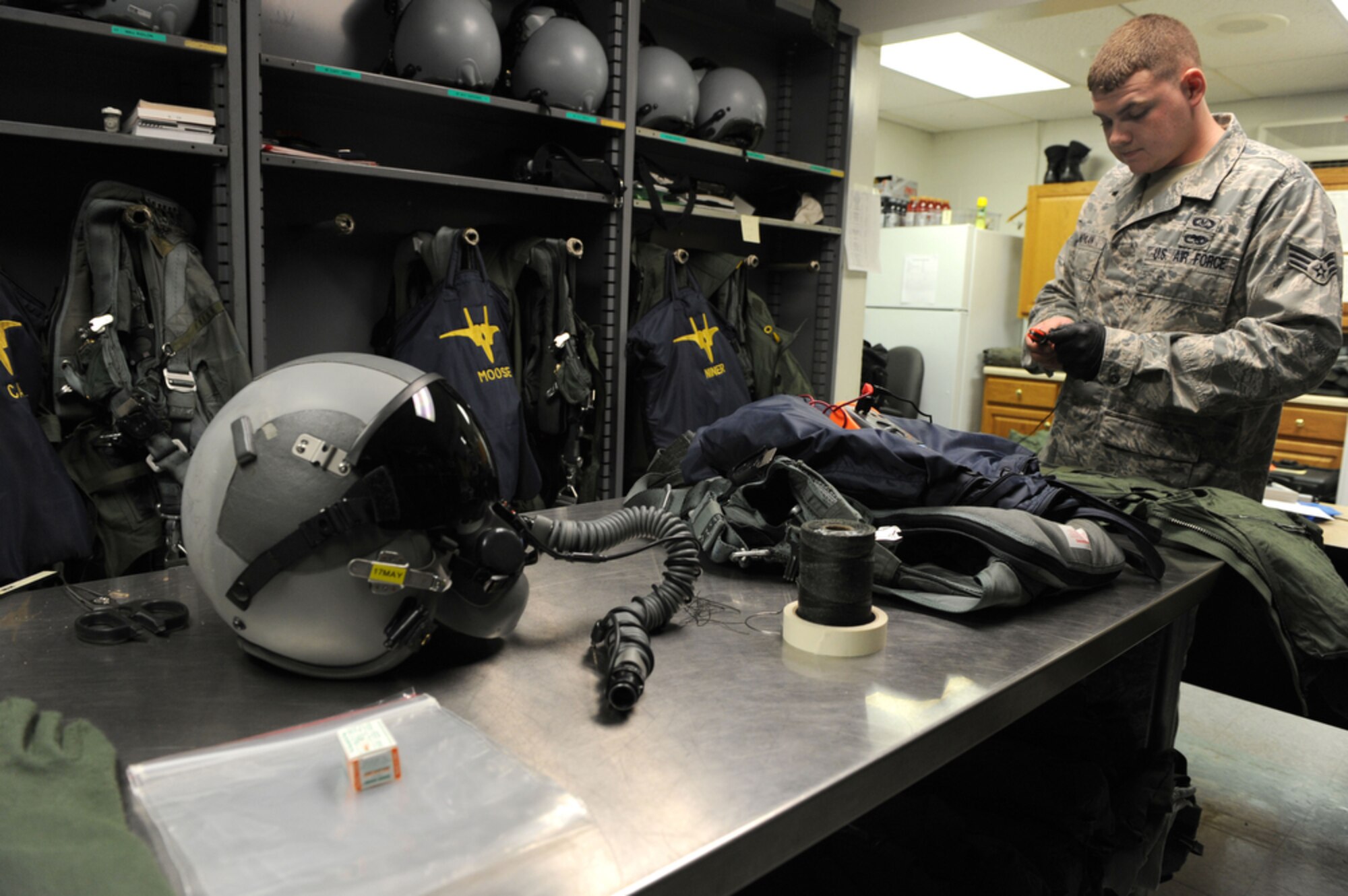 JOINT BASE PEARL HARBOR-HICKAM, Hawaii - Senior Airman Kenny Moylan, an aircrew flight equipment journeyman with the 19th Fighter Squadron, Elmendorf AFB, Alaska conducts an inspection of safety equipment for an incentive flyer on March 23, while at Joint Base Pearl Harbor-Hickam, Hawaii. Airman Moylan ensures that helmets, masks, oxygen devices, life rafts, G-suits, parachutes and harnesses will operate correctly for the pilots of the 19th FS while they participate in training exercise with the 199th FS of the Hawaii Air National Guard. (Air Force photo by Tech. Sgt. Cohen A. Young)